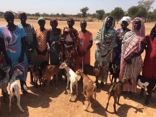Women Smiling with their goats.jpg