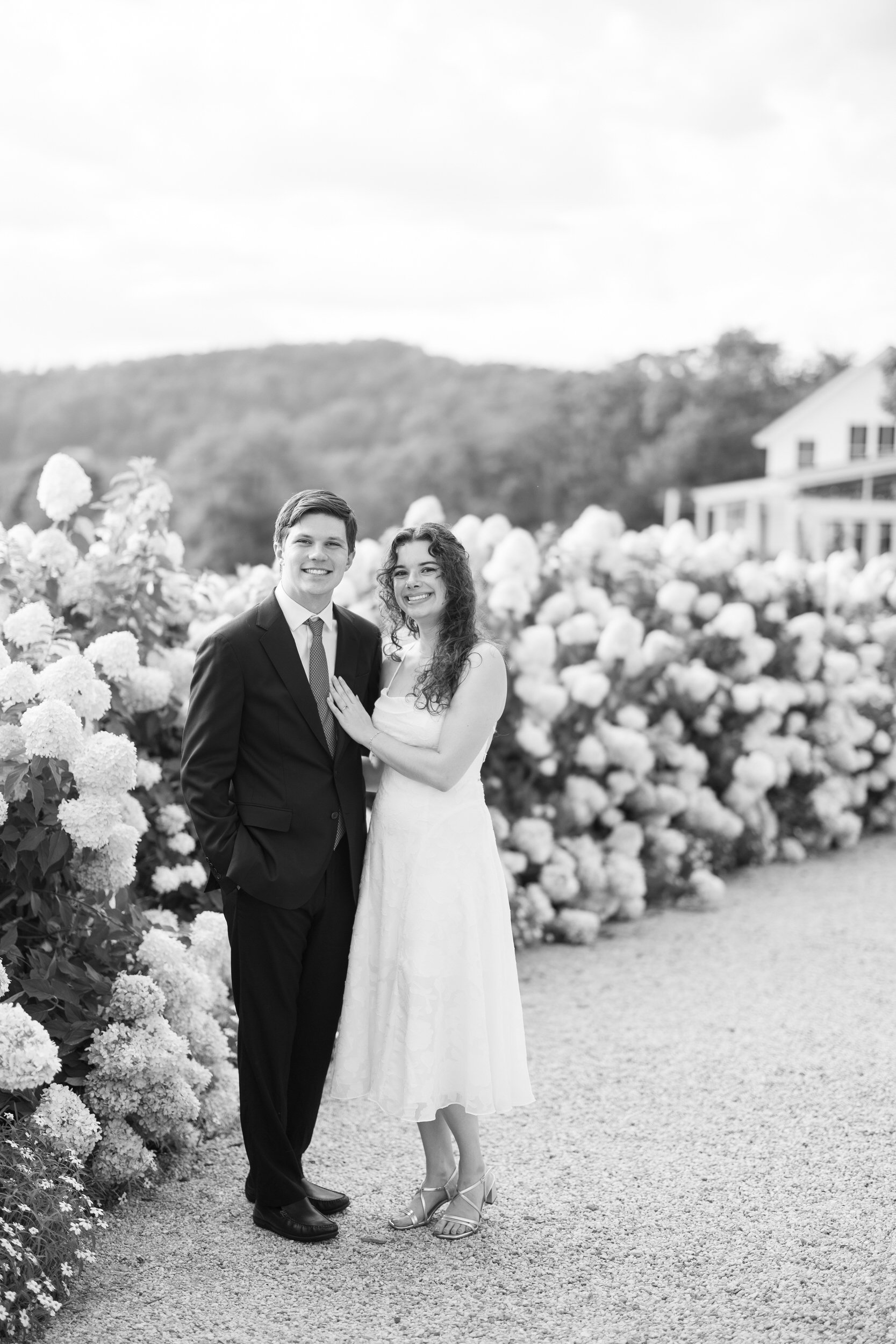 Couple walking through the white hydrangea garden during their Pippin Hill engagement session