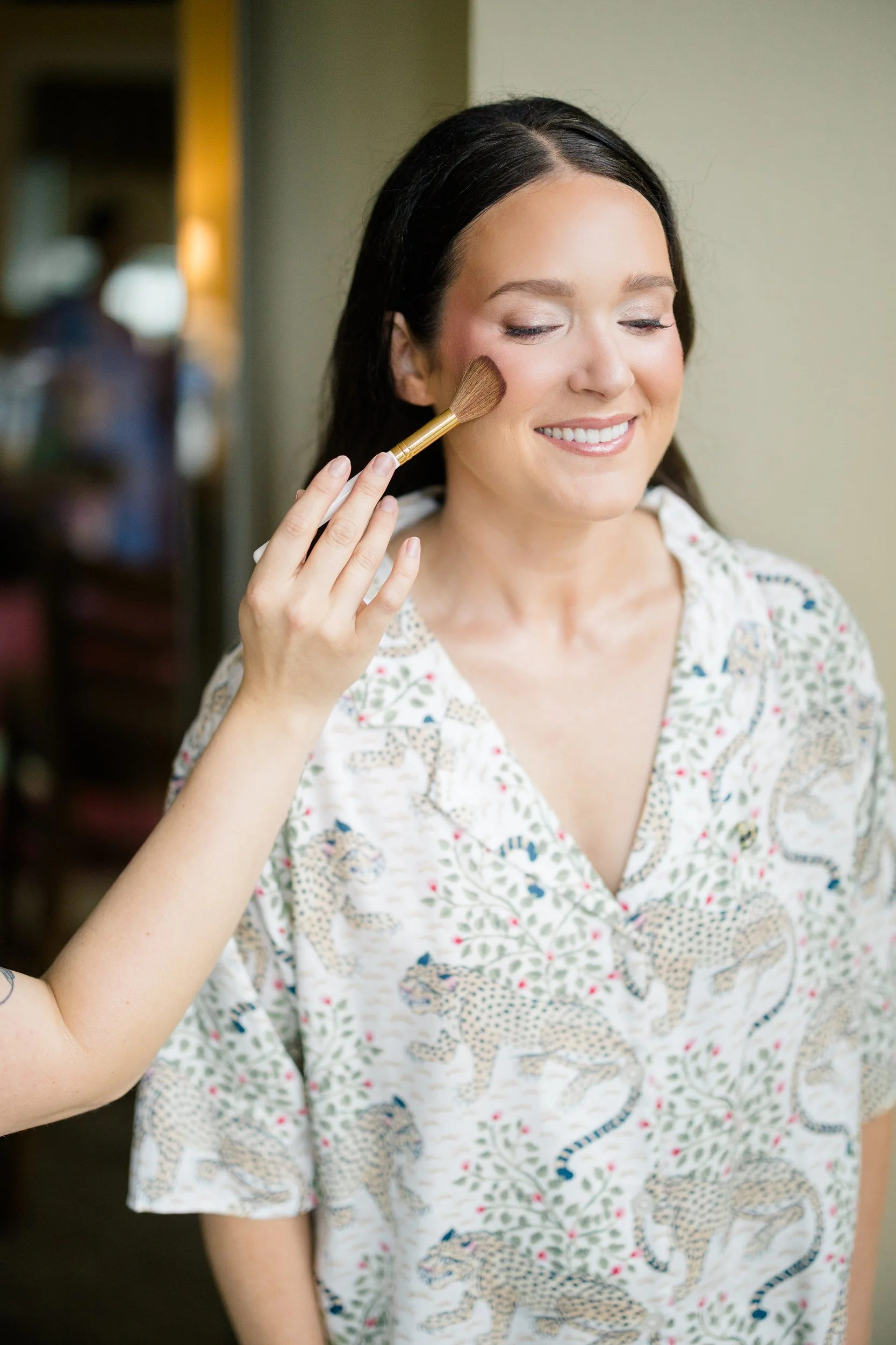 Bride preparing for her colorful Connors Center wedding surrounded by vibrant garden-inspired florals.