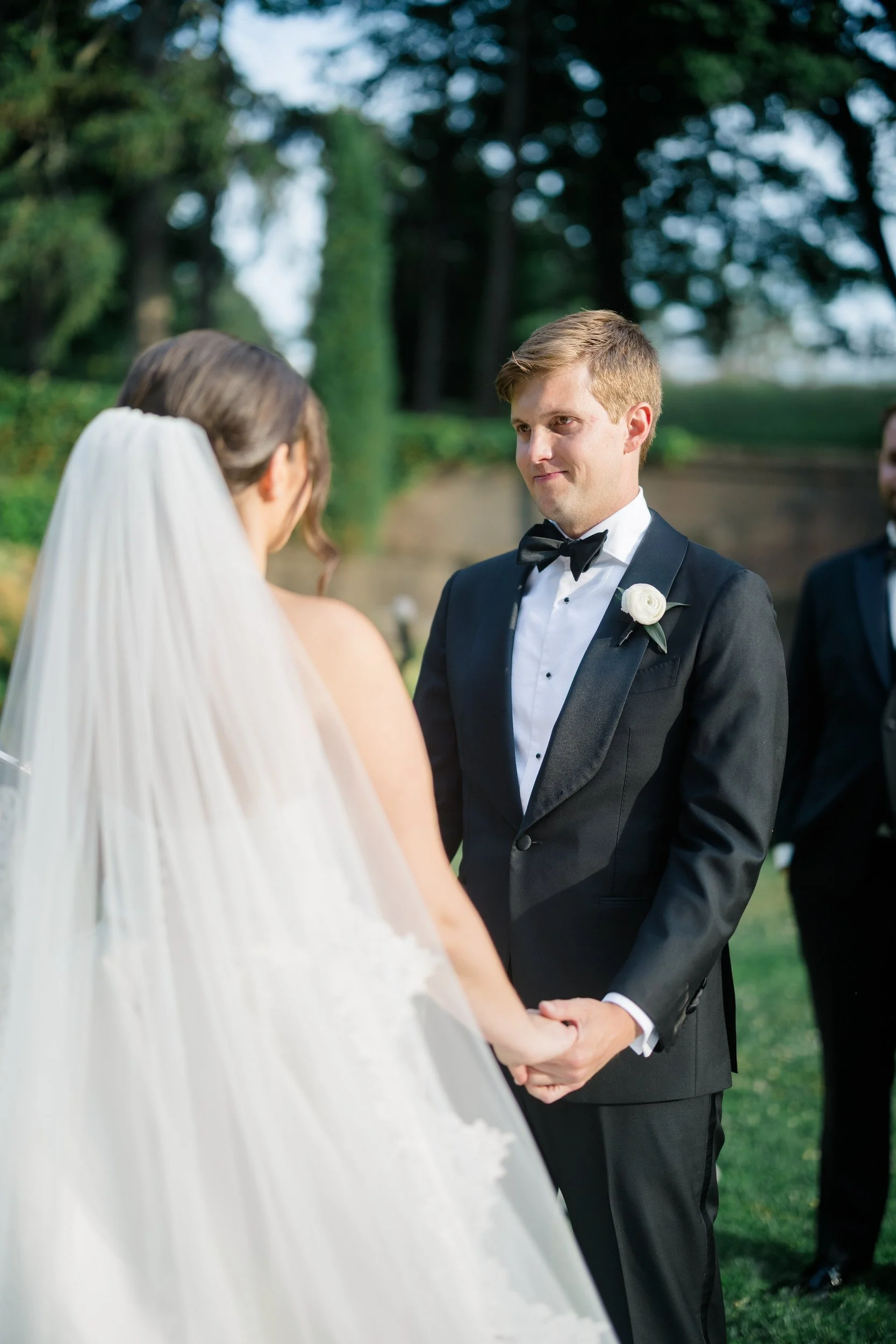 Couple exchanging vows during their outdoor ceremony at Castle Hill on the Crane Estate.