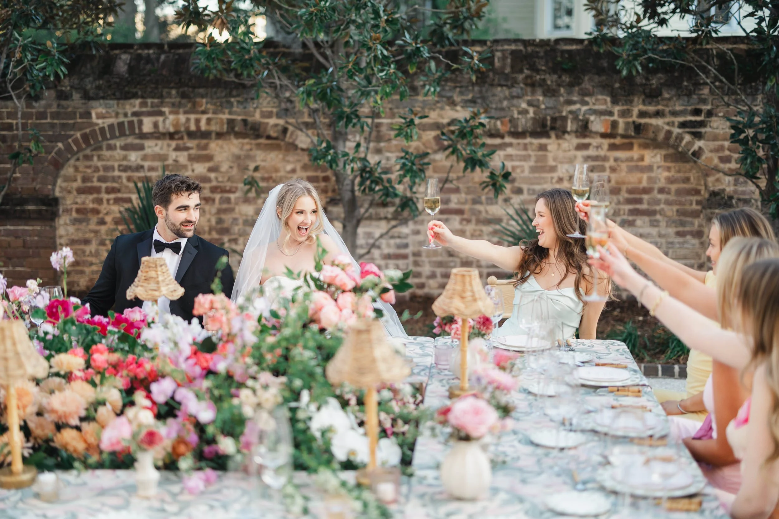 Bride and groom sharing a joyful moment during their spring wedding reception at The Gadsen House in Charleston, South Carolina.