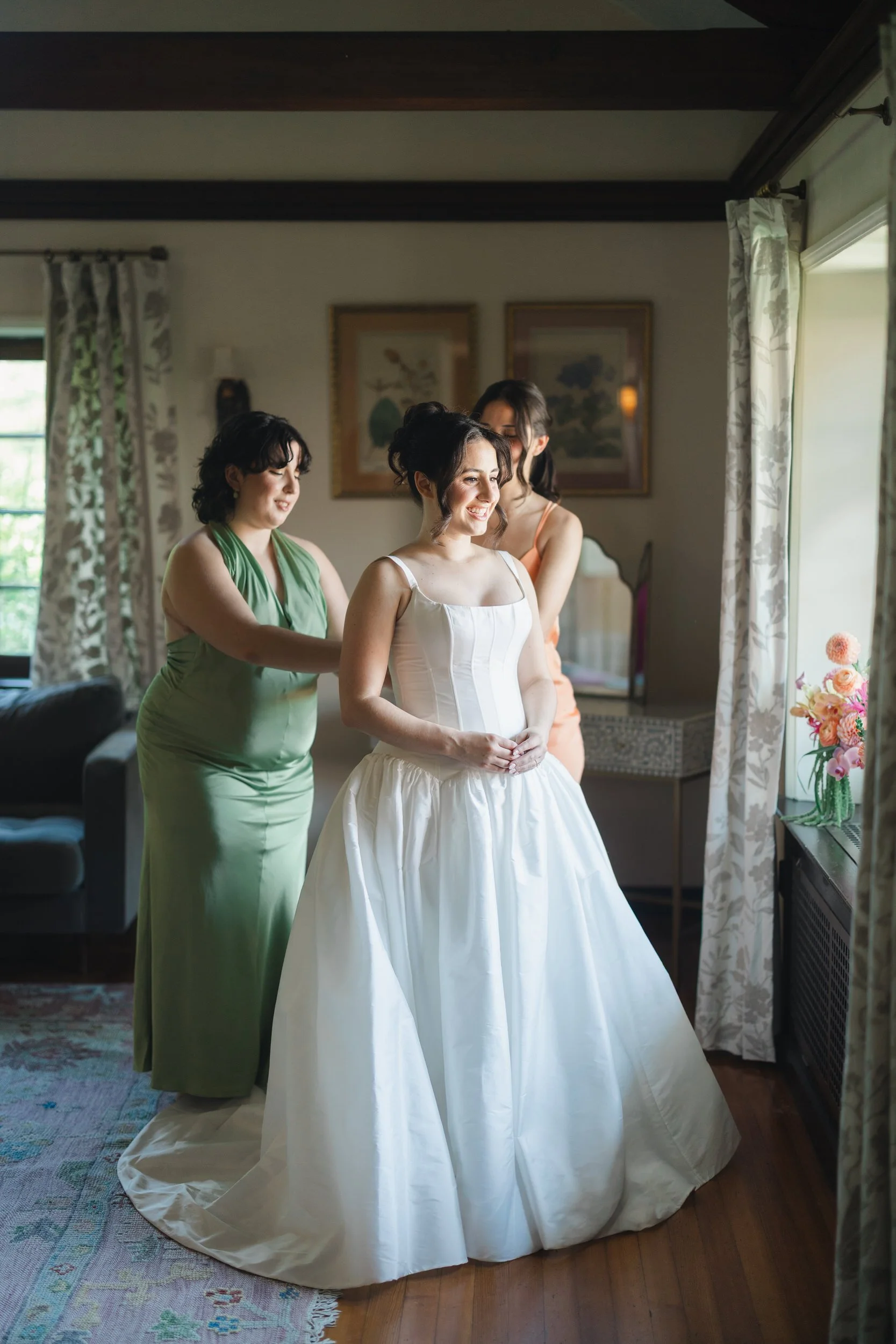 Bride getting ready at Willowdale Estate wearing a classic basque waist wedding dress and hip length veil