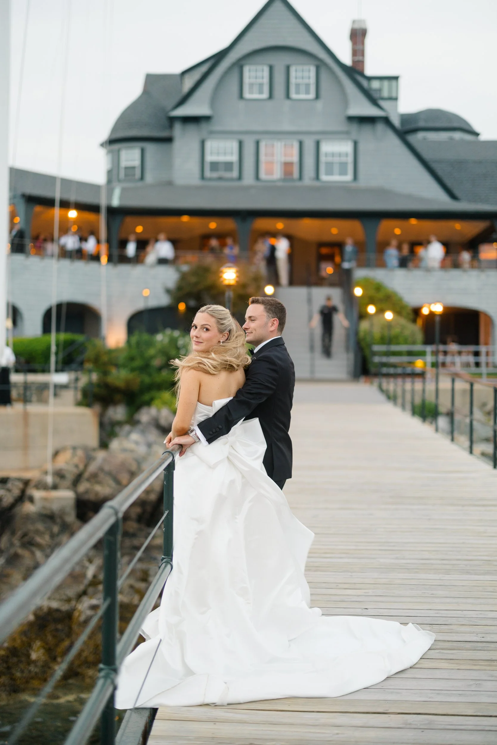 Sunset wedding portraits on the dock at Corinthian Yacht Club overlooking Marblehead Harbor.
