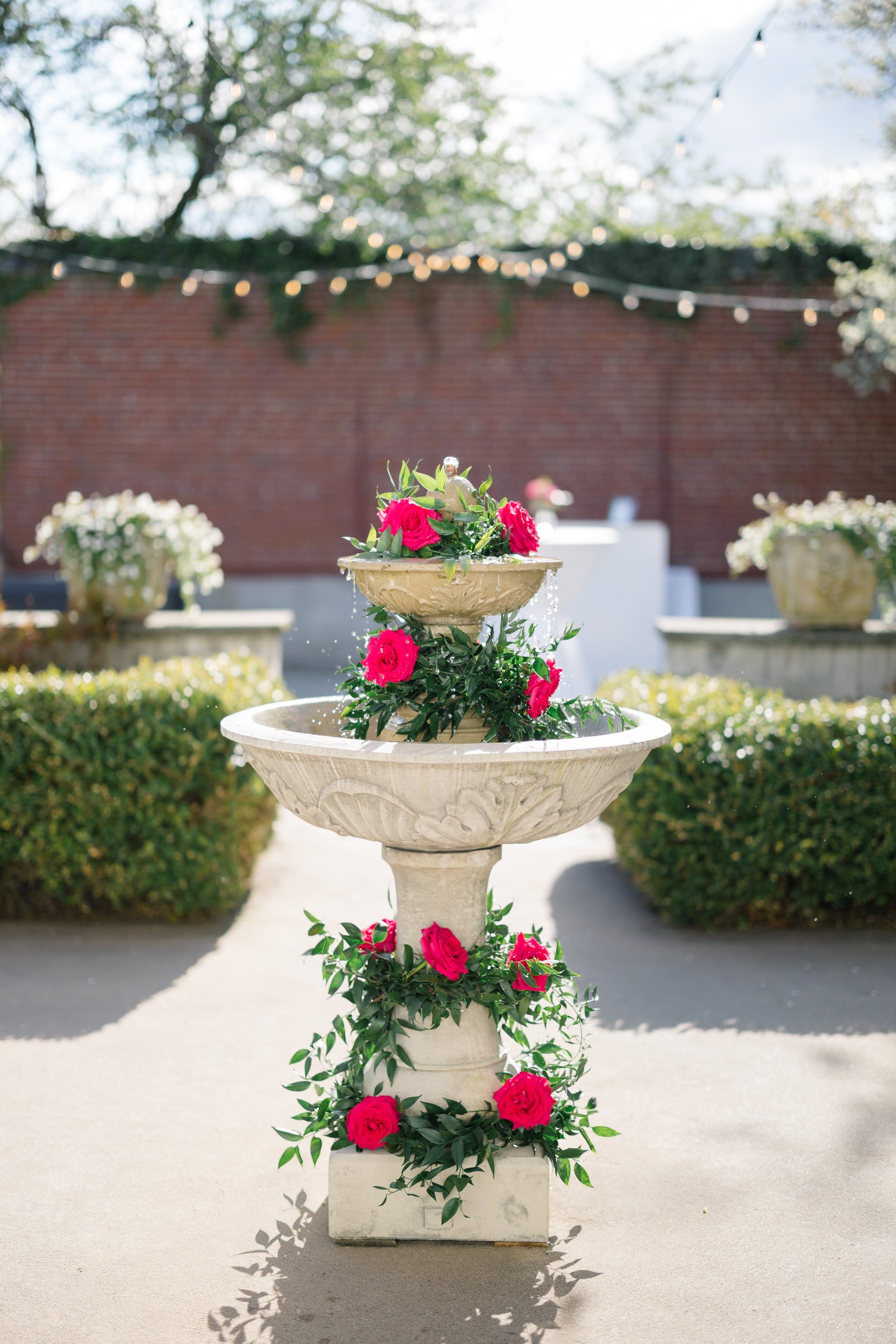 Elegant wedding fountain with pink, mauve, and green floral arrangements at Misselwood Estate