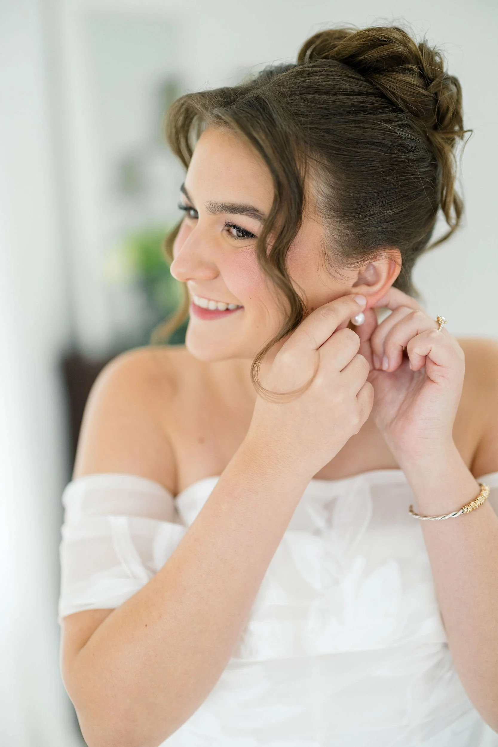 Bride putting on her wedding dress before her garden wedding in Beverly, MA.