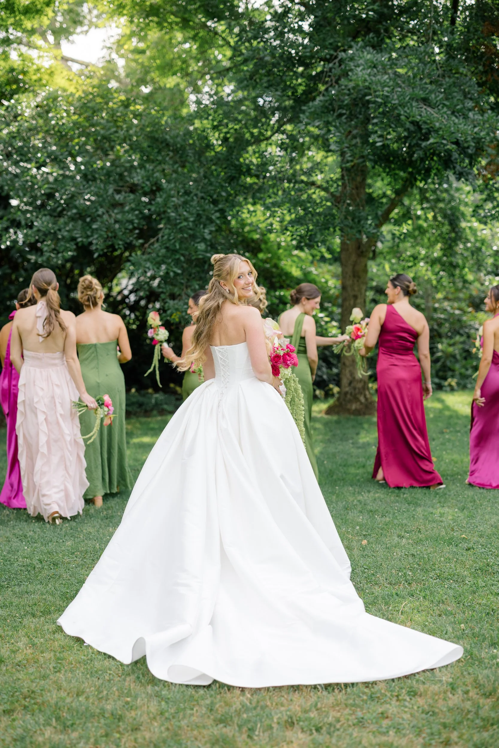 Wedding party wearing colorful dresses inspired by a garden party aesthetic
