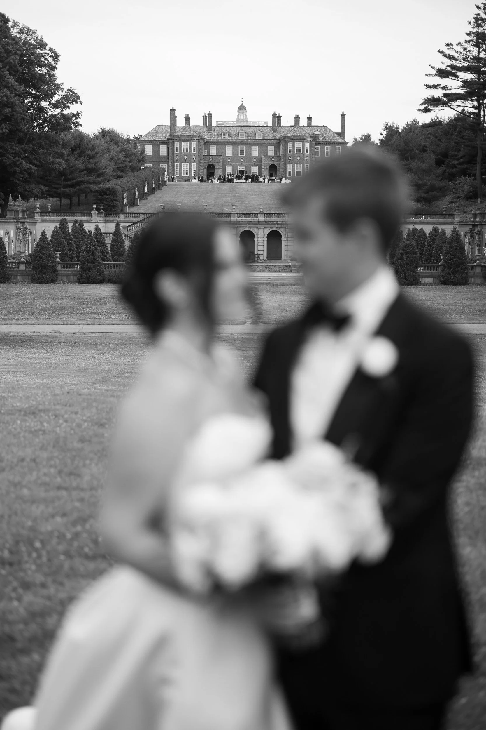 Editorial wedding portraits captured at golden hour with the Crane Estate estate grounds glowing in the background.