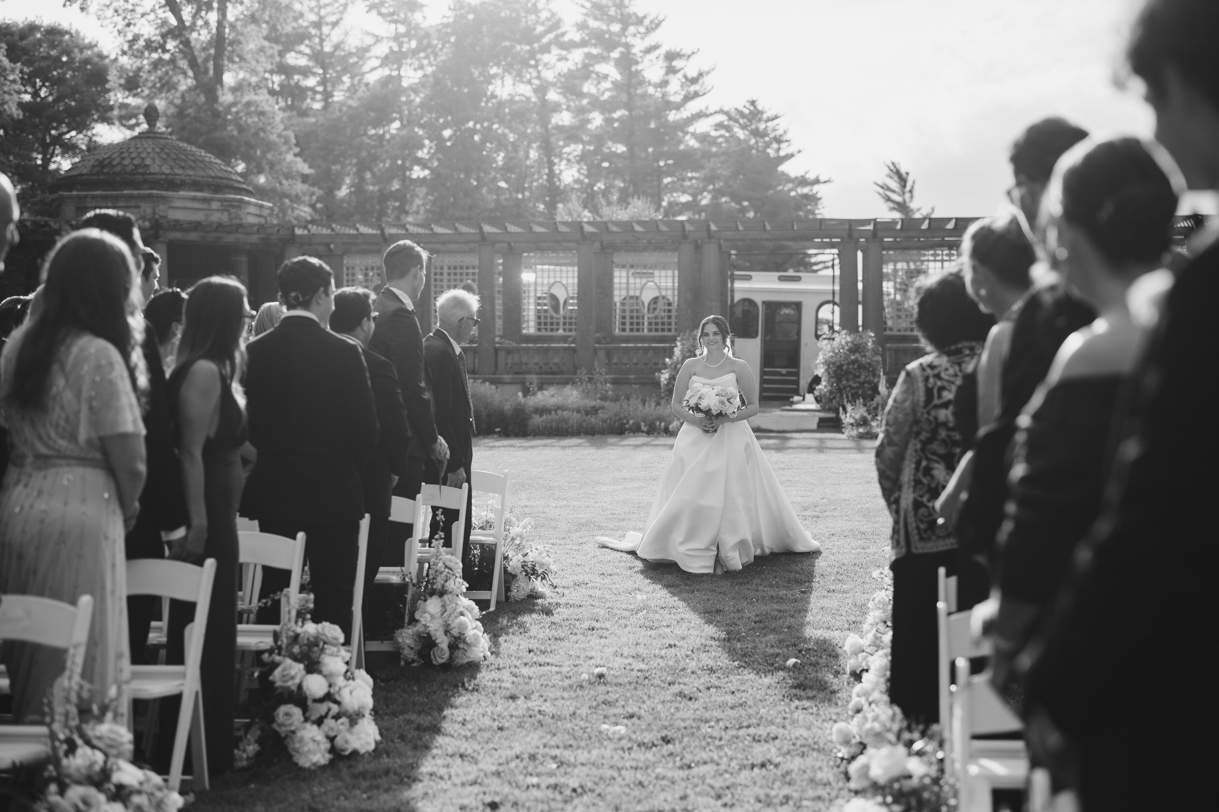 Bride walking down the aisle in the Italian Garden at Castle Hill on the Crane Estate in Ipswich, Massachusetts.