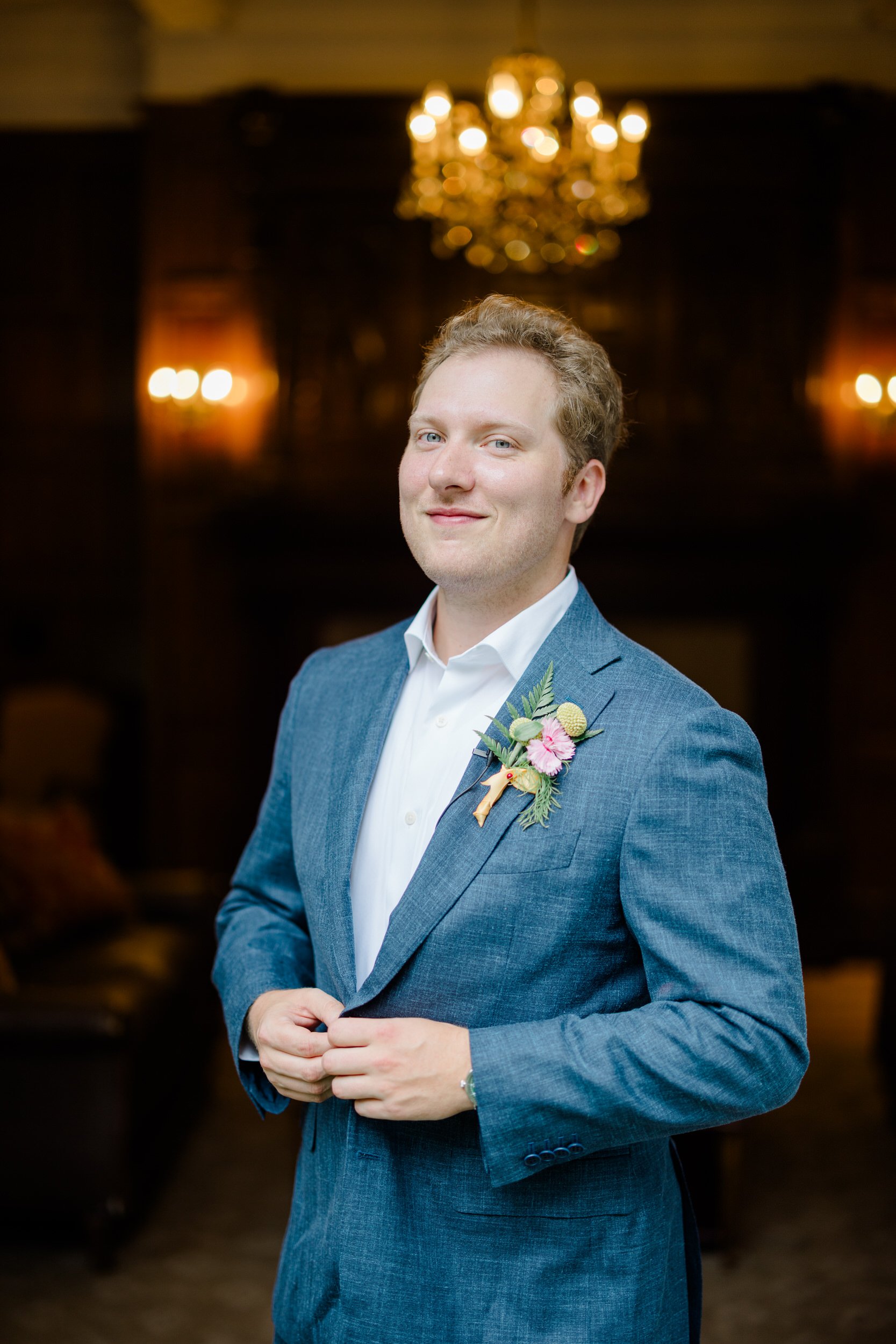 Groom getting ready for a colorful garden wedding at the Connors Center.