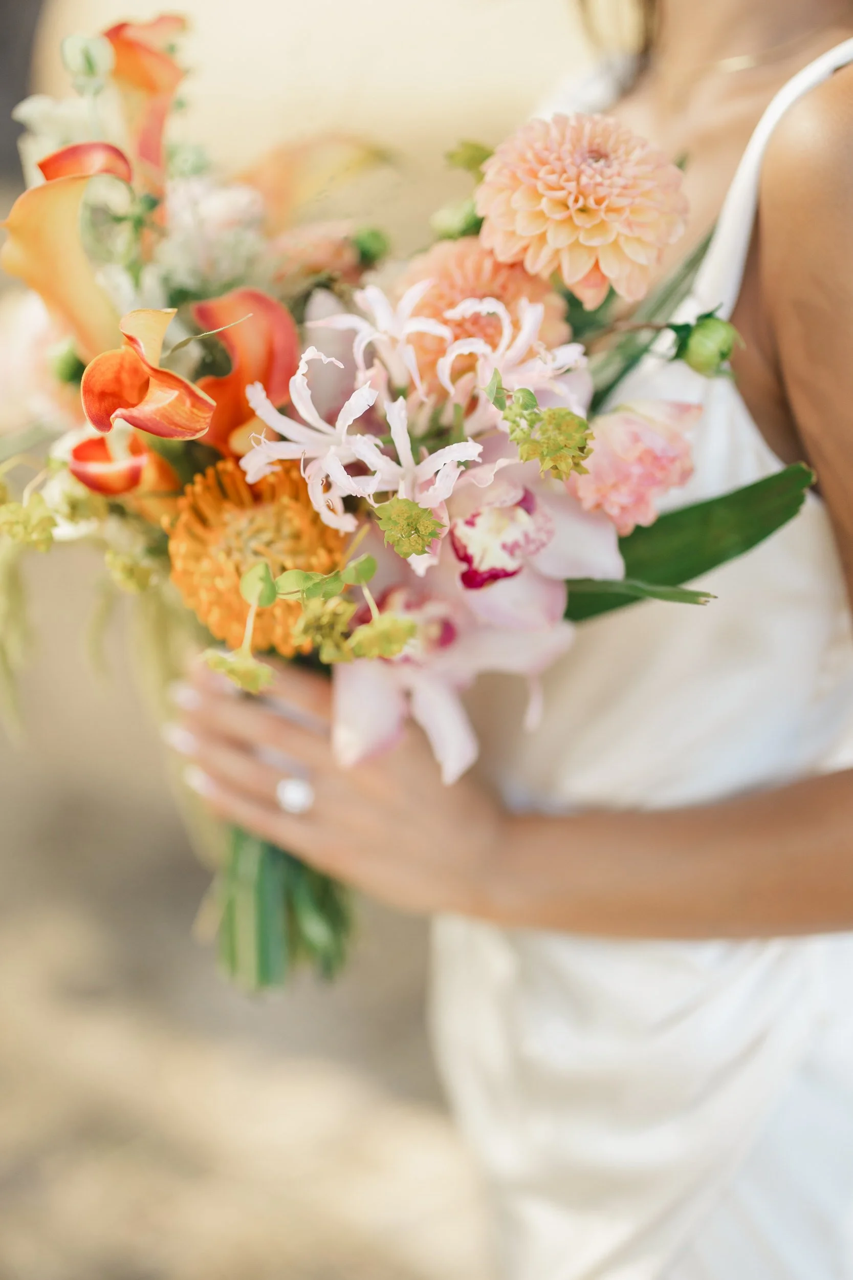 Bride holding tropical bouquet during Oahu beach elopement