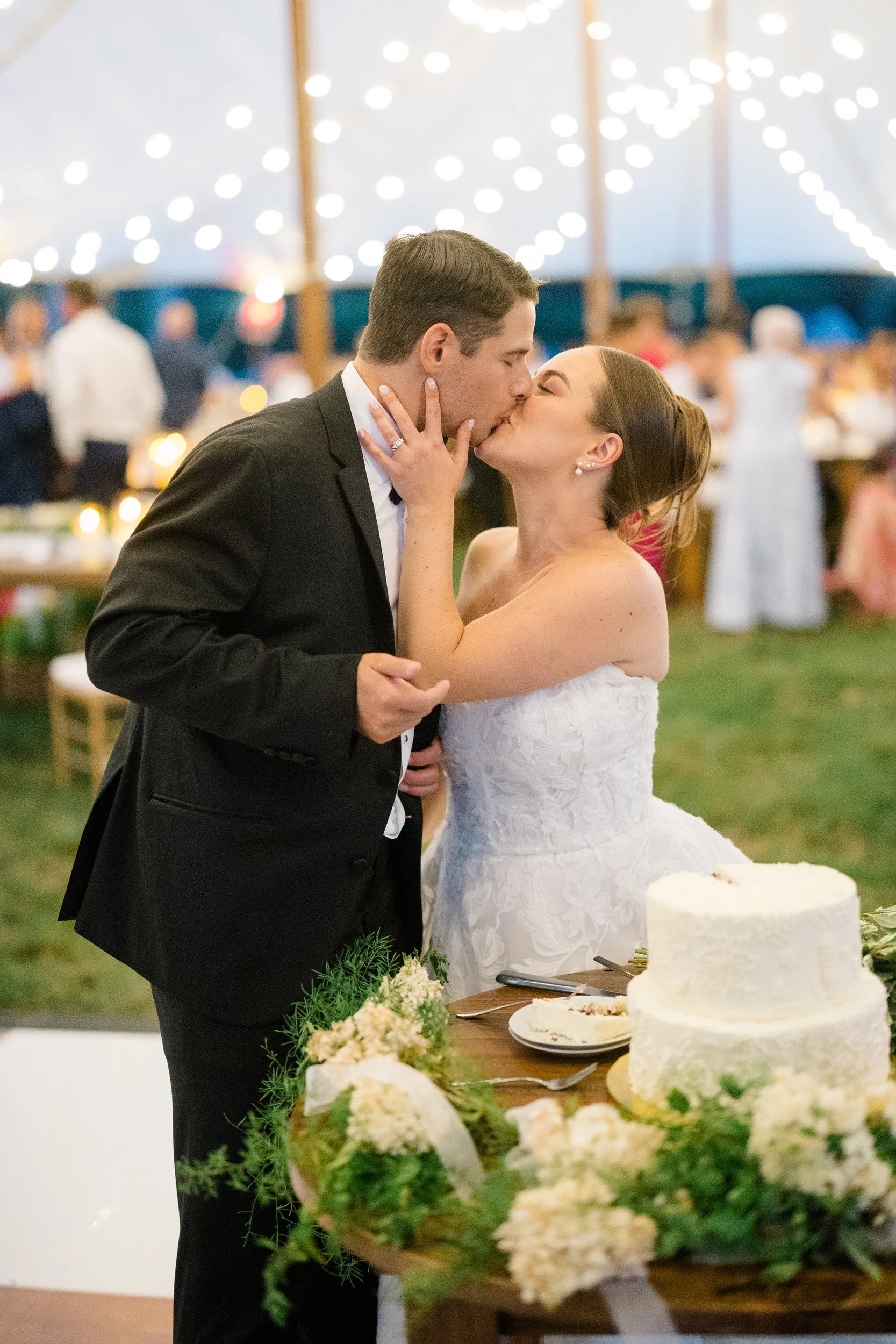 Newlyweds cutting their wedding cake during the evening reception.