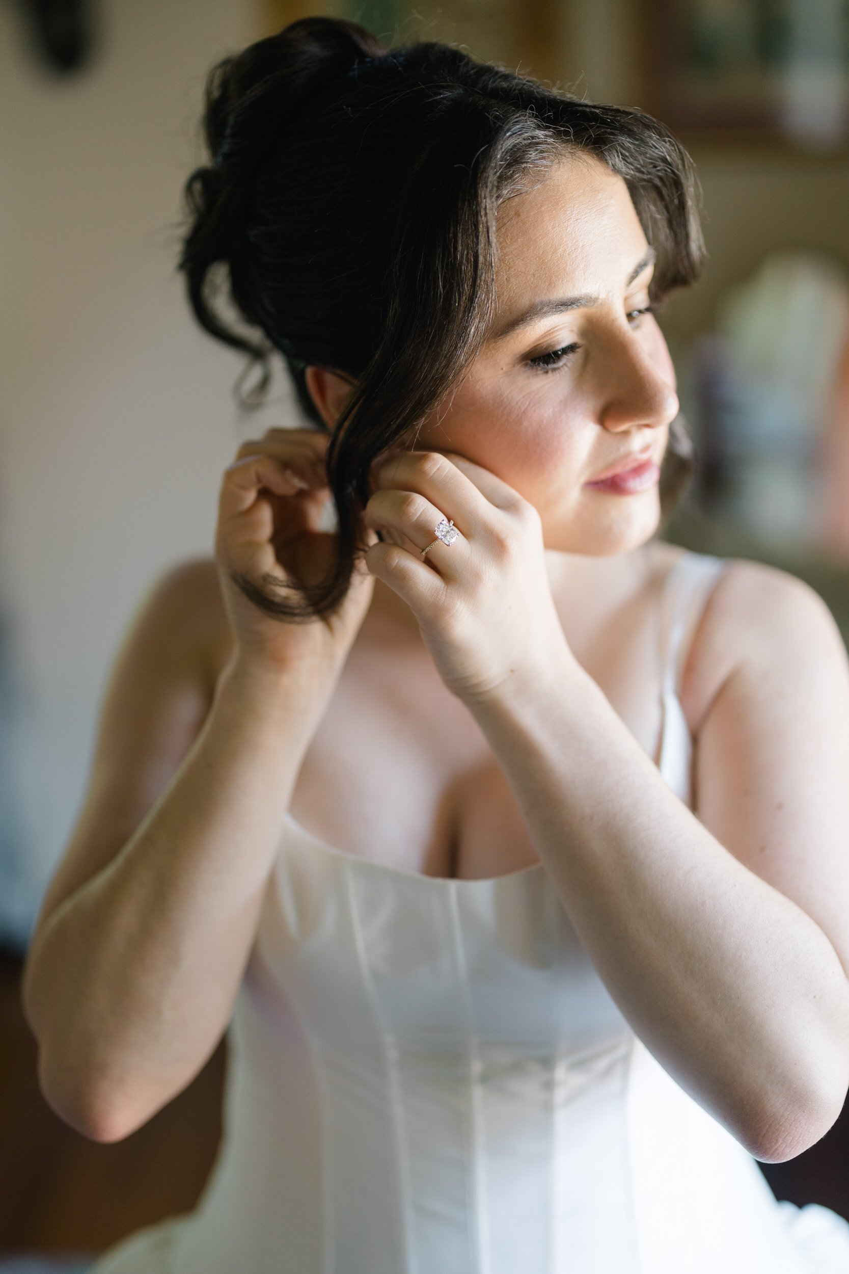 Soft editorial bridal preparation image featuring basque waist gown at Willowdale Estate
