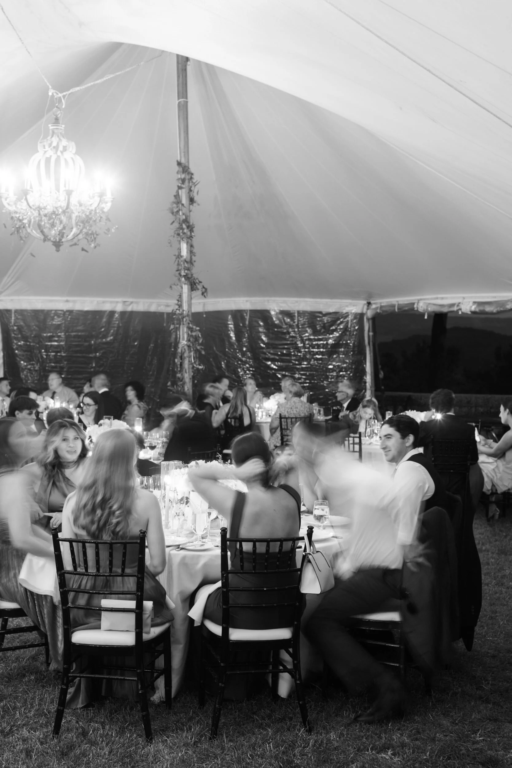 Wedding dinner celebration inside the sailcloth tent at Castle Hill overlooking the North Shore landscape.