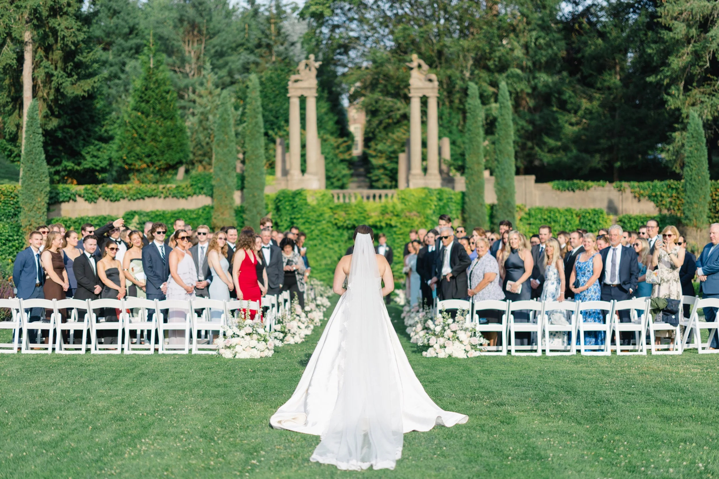 Bride walking down the aisle in the Italian Garden at Castle Hill on the Crane Estate in Ipswich, Massachusetts.
