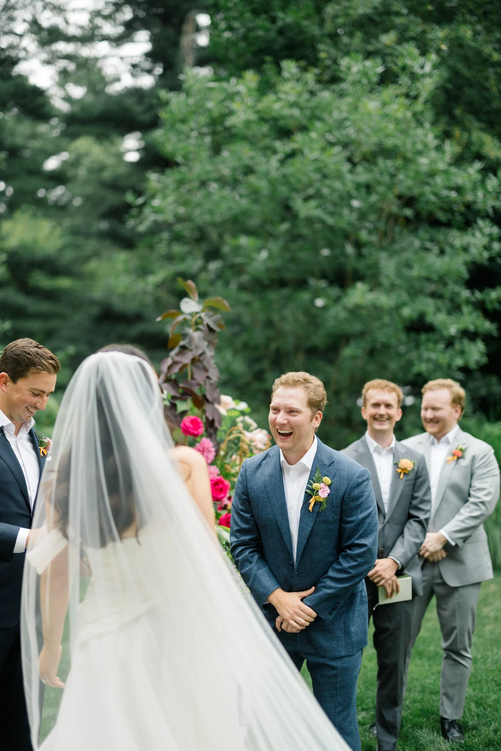 Colorful garden wedding ceremony at the Connors Center surrounded by vibrant seasonal florals.