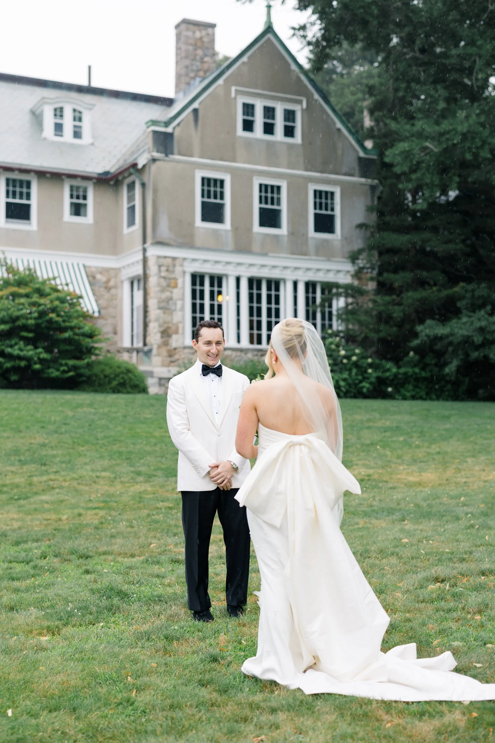 Emotional first look photographed before a Rhode Island garden wedding.