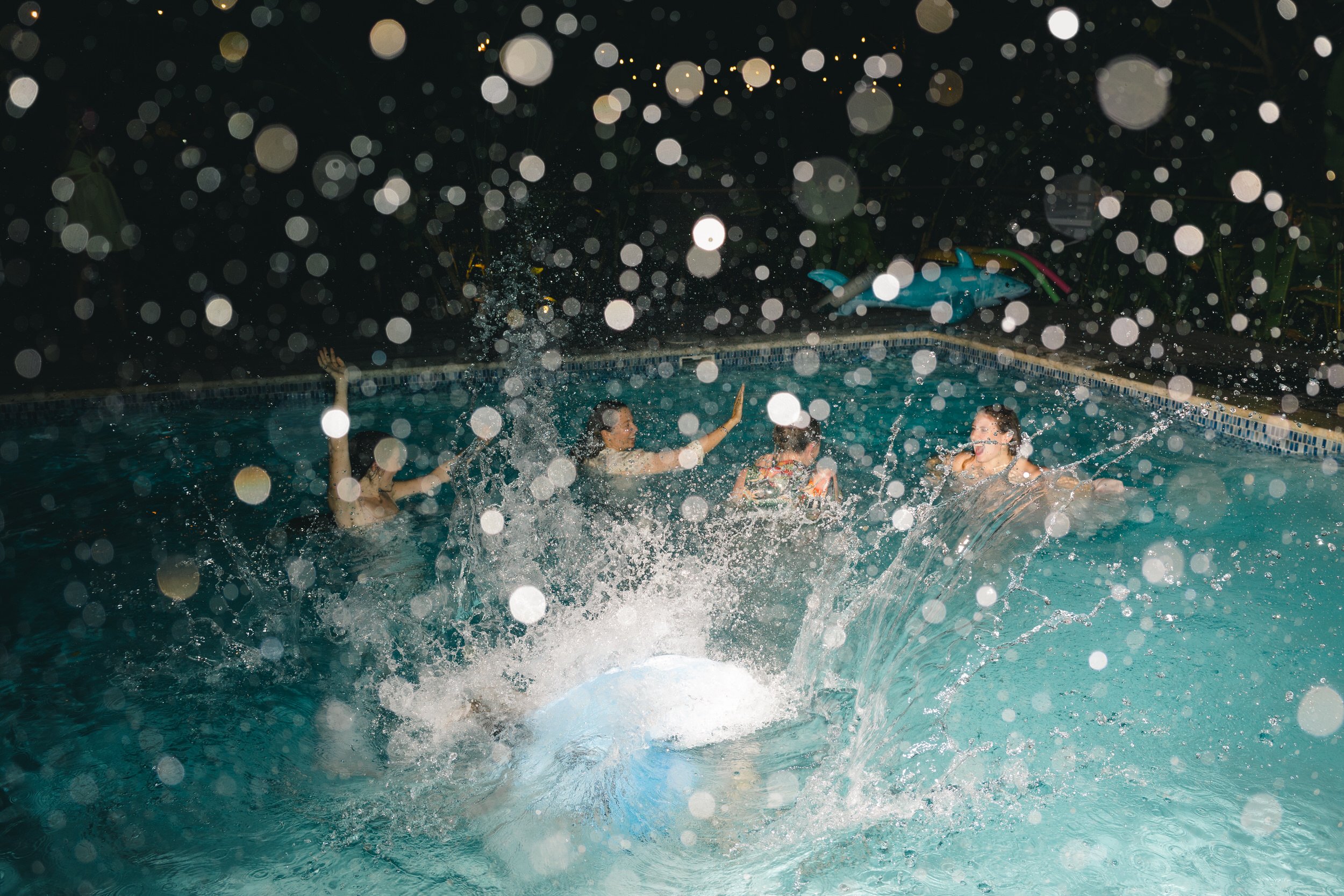 Documentary wedding photography of a tropical pool after-party in St. Thomas.