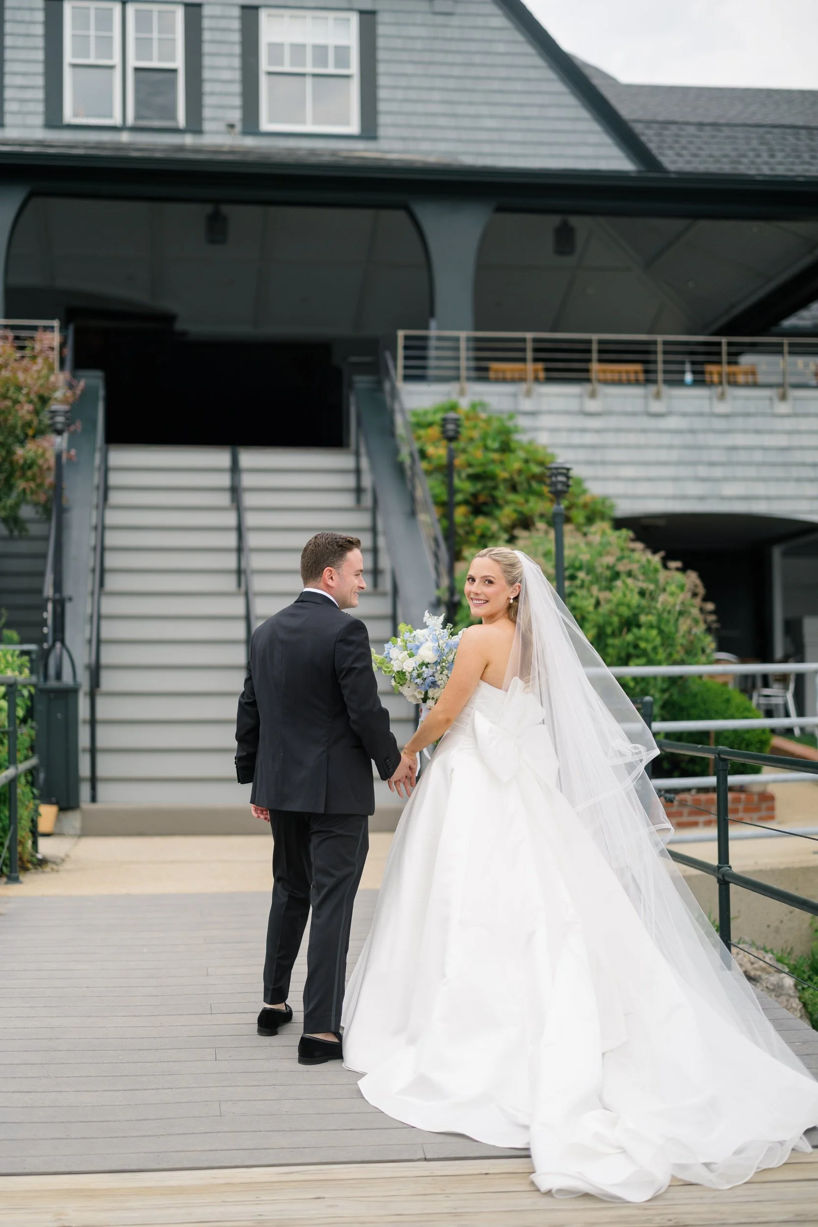 Bride and groom portraits overlooking Marblehead Harbor during a coastal New England wedding.