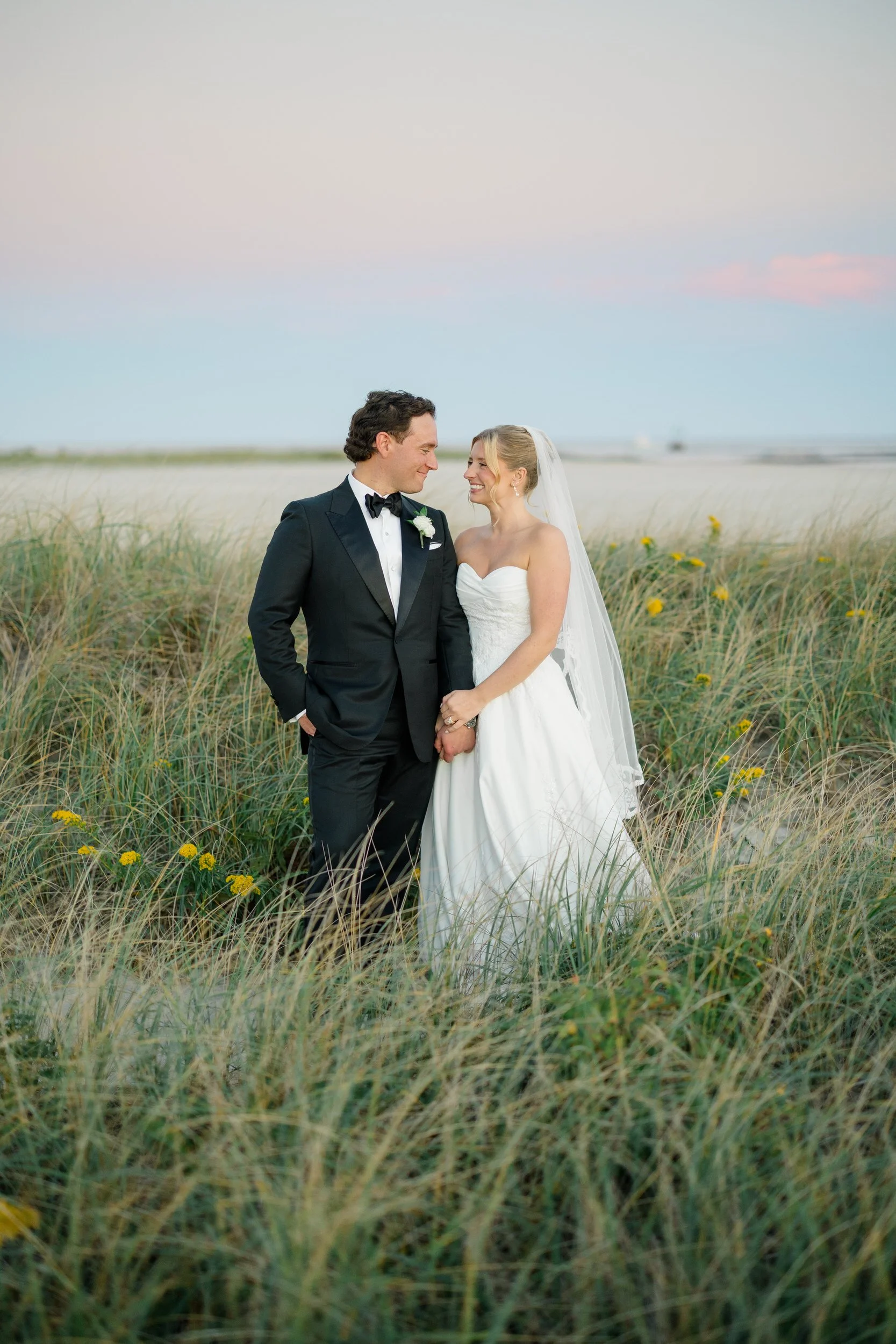 1. Coastal sunset portraits of the newlyweds during their fall wedding on Cape Cod.