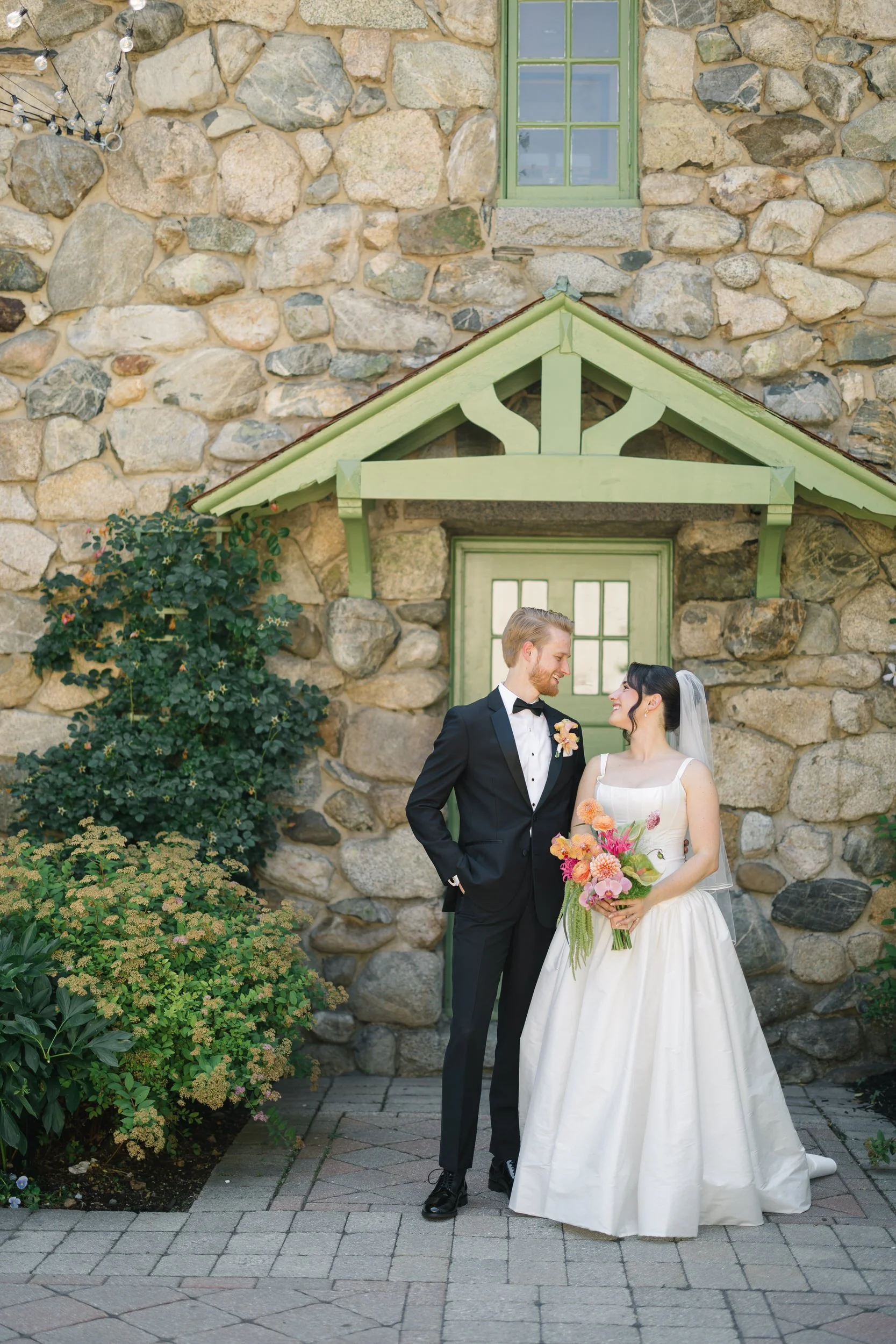 Newlywed couple portraits at Willowdale Estate featuring colorful tropical floral wedding design