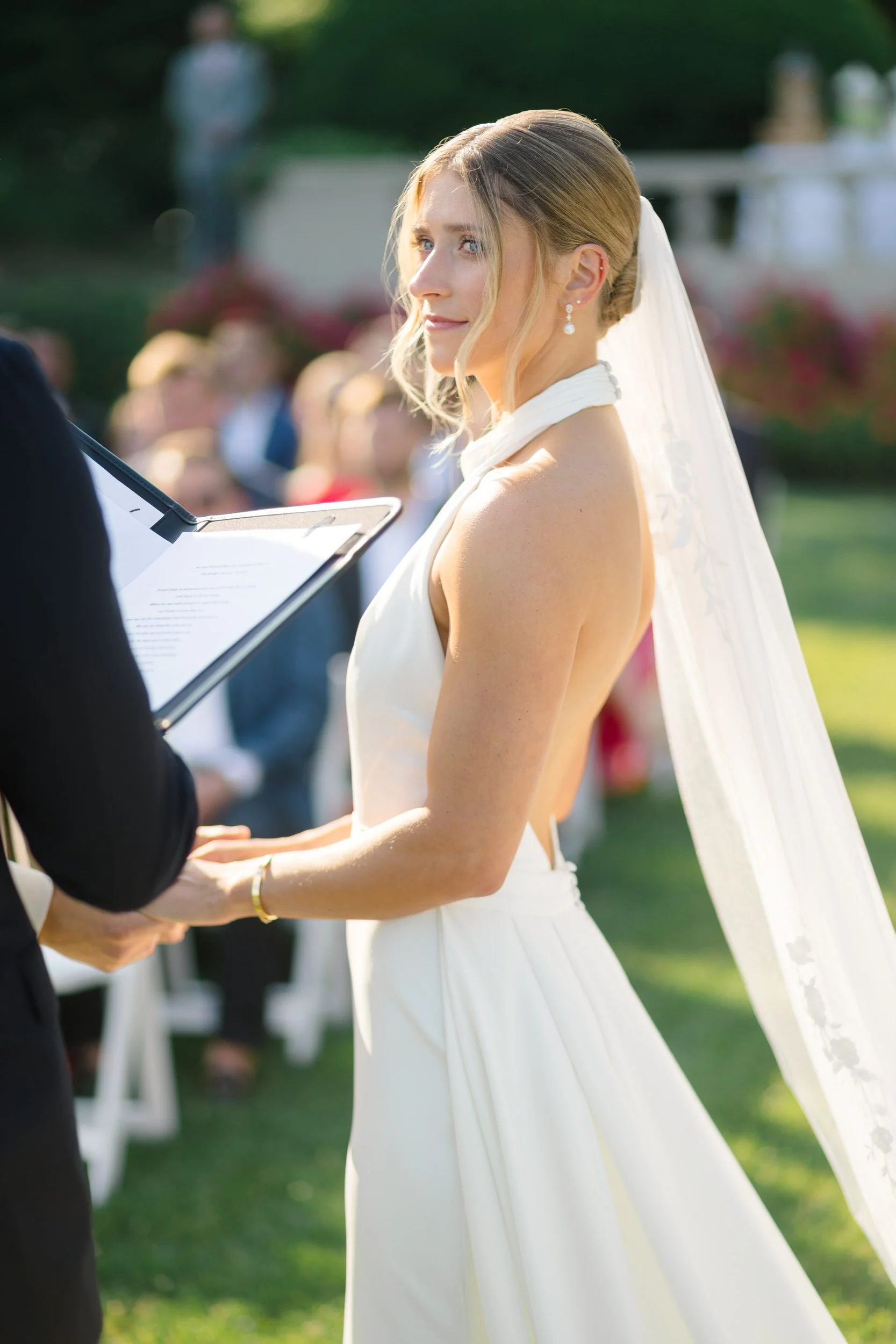 Emotional wedding ceremony surrounded by family, friends, and ocean views.