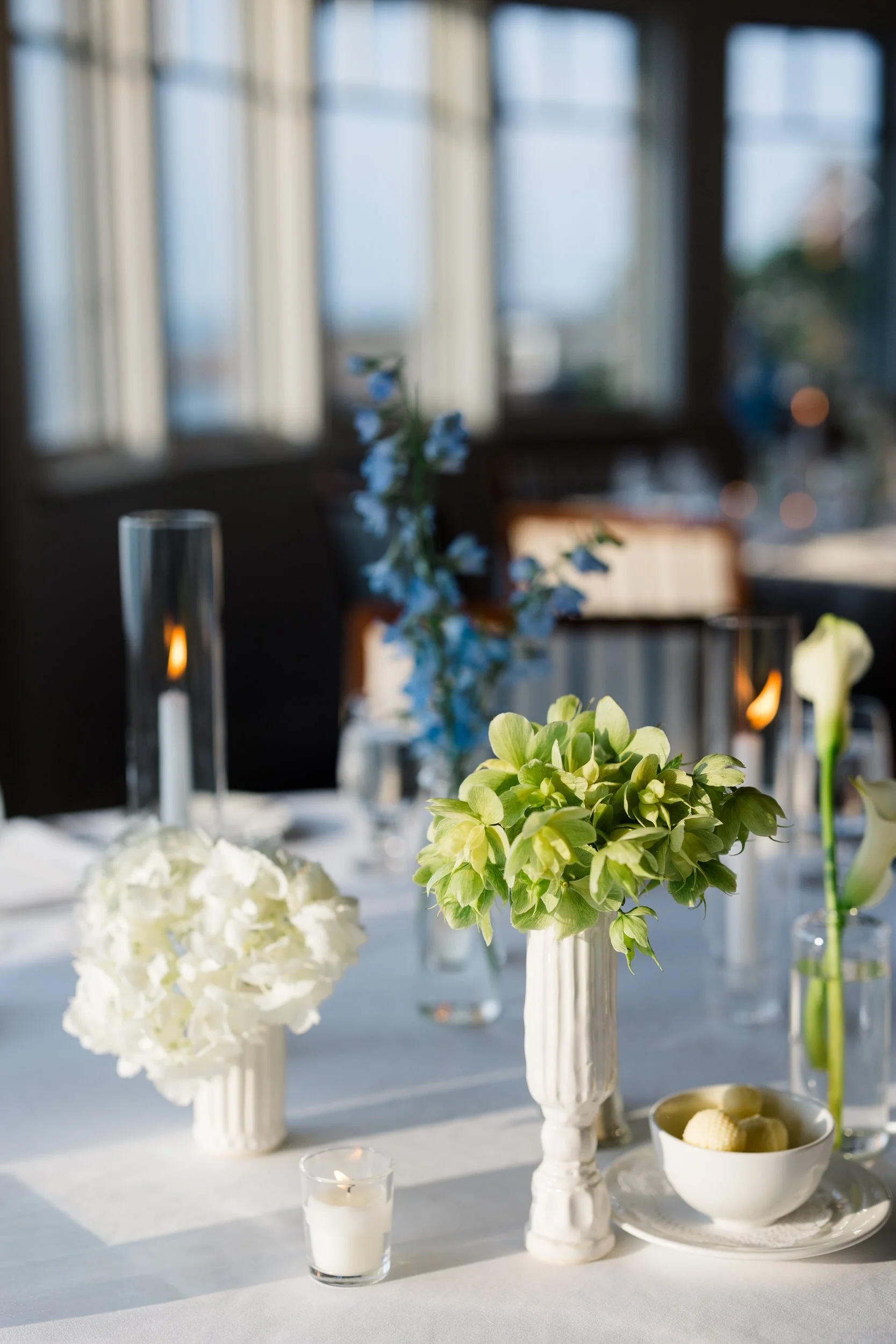 Timeless New England wedding reception design overlooking Marblehead Harbor with sailboats visible in the distance.