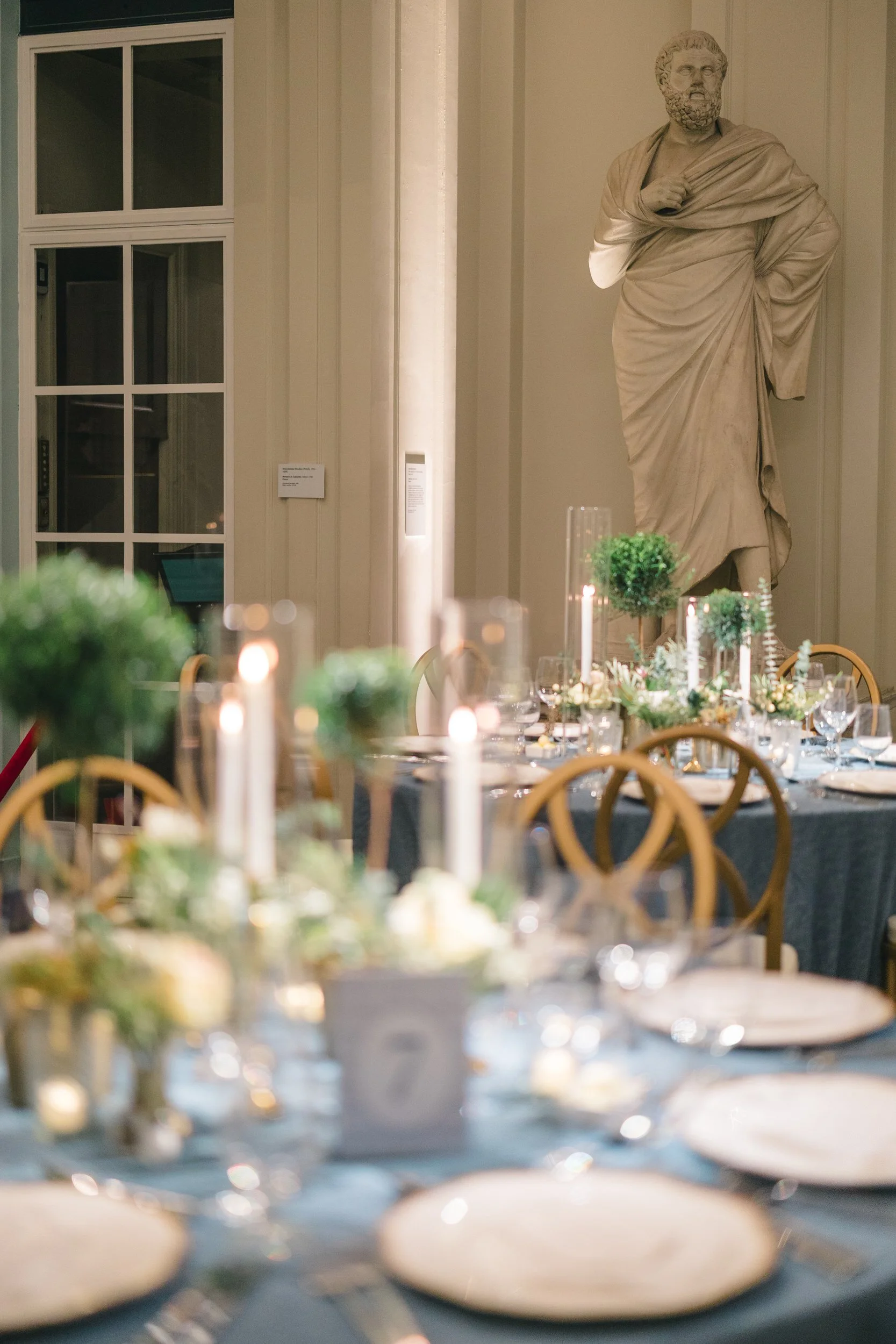 Floral arrangement styled among candles at the Boston Athenaeum dinner.