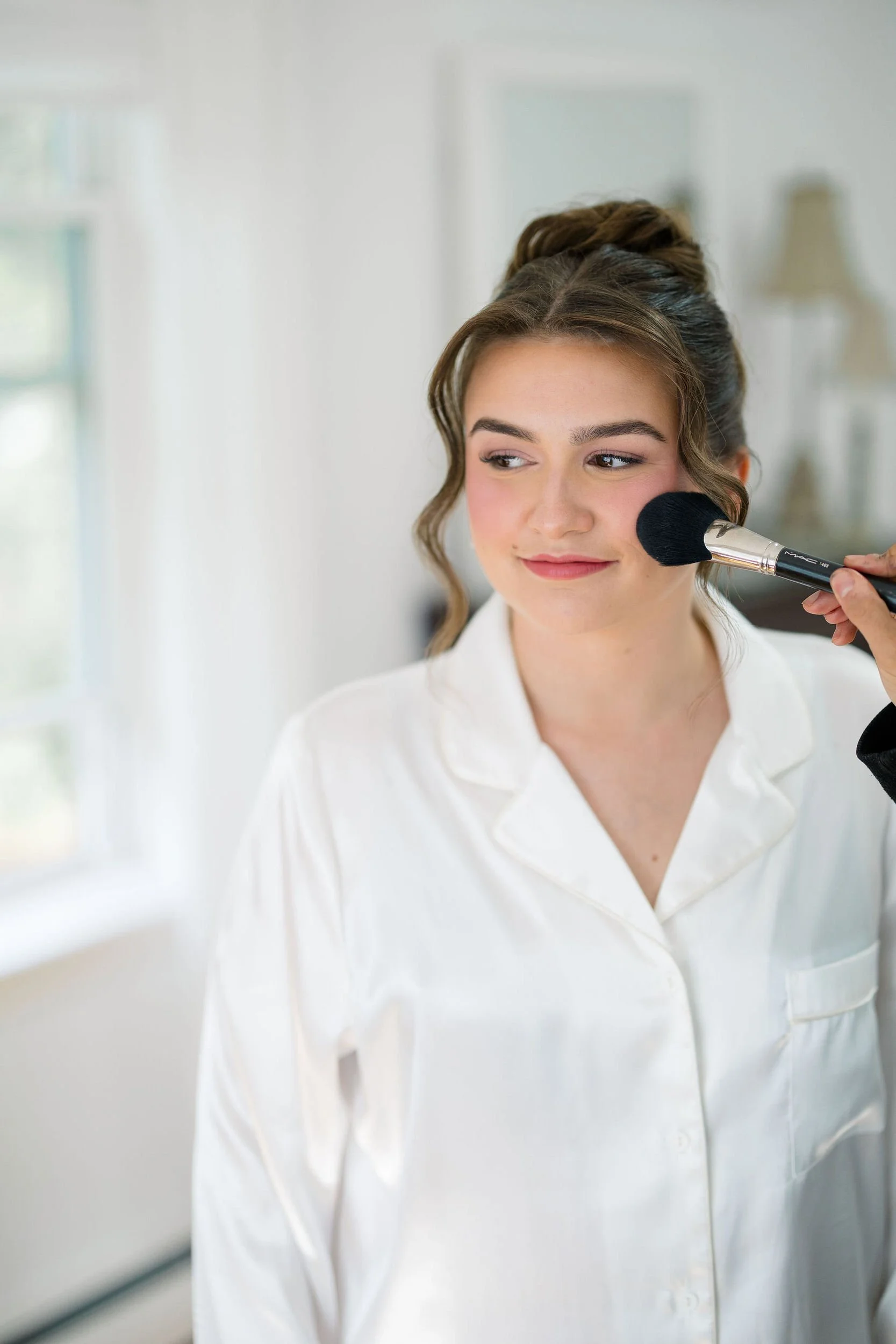 Bride getting ready on her wedding day at Long Hill in Beverly, Massachusetts.