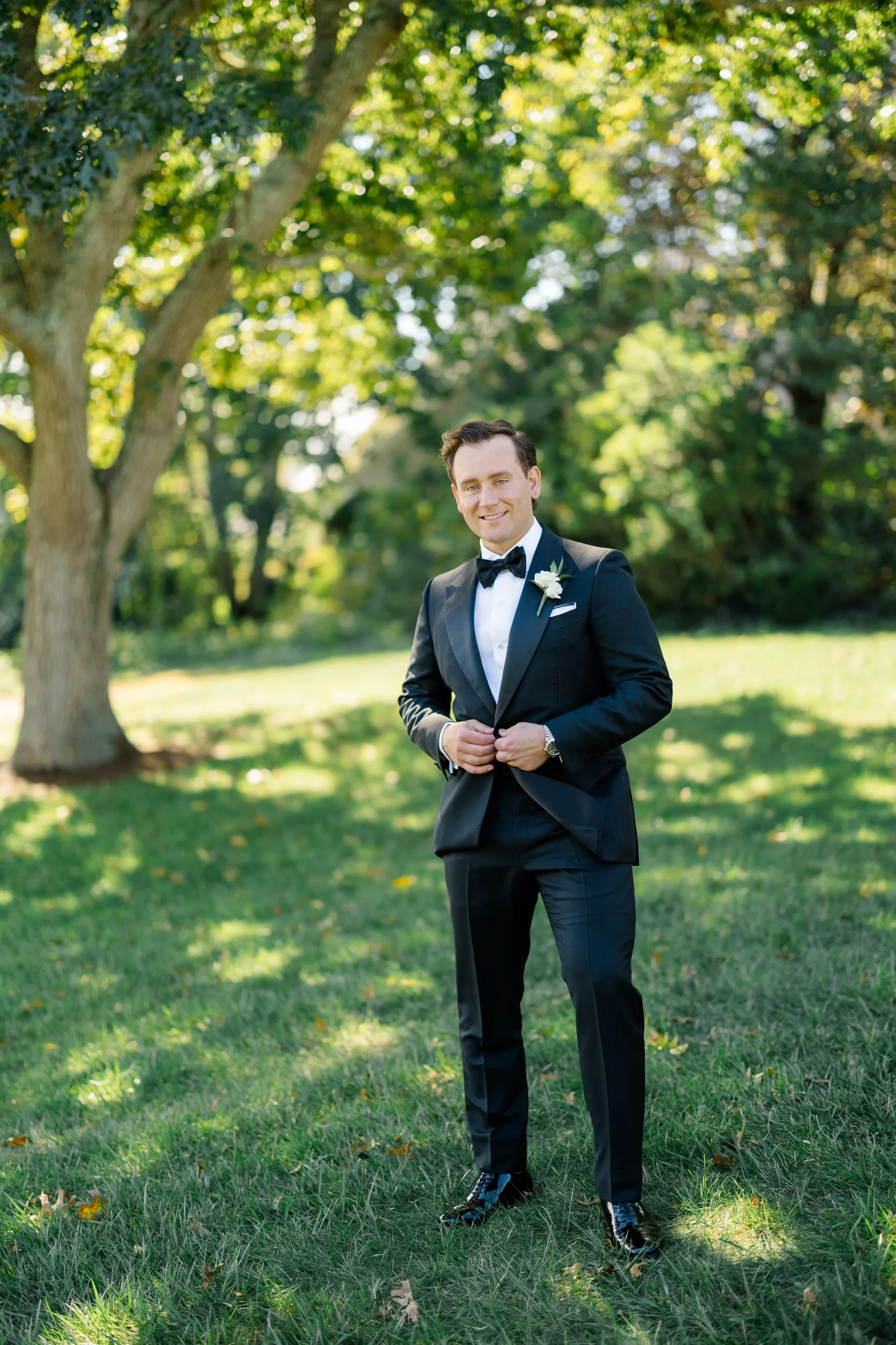 Groom posing in his wedding suit at a coastal Massachusetts wedding venue.