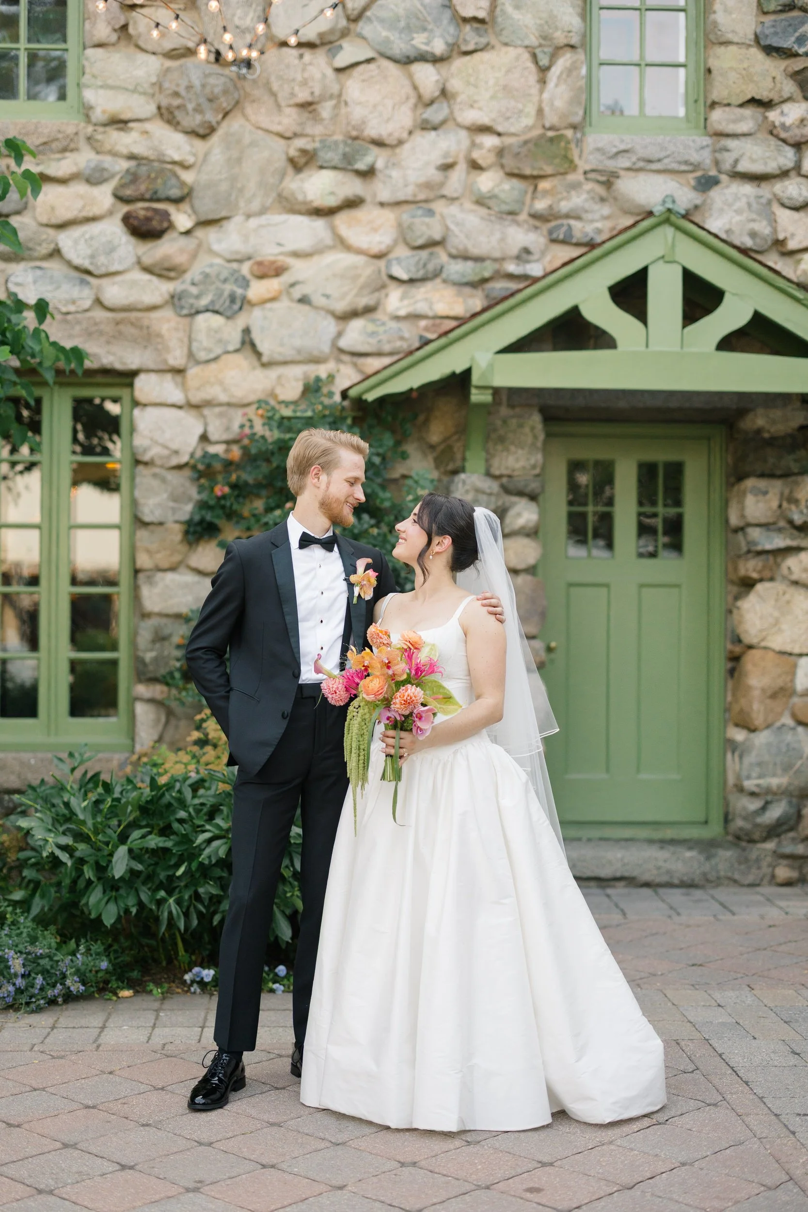 Newlywed couple portraits at Willowdale Estate featuring colorful tropical floral wedding design