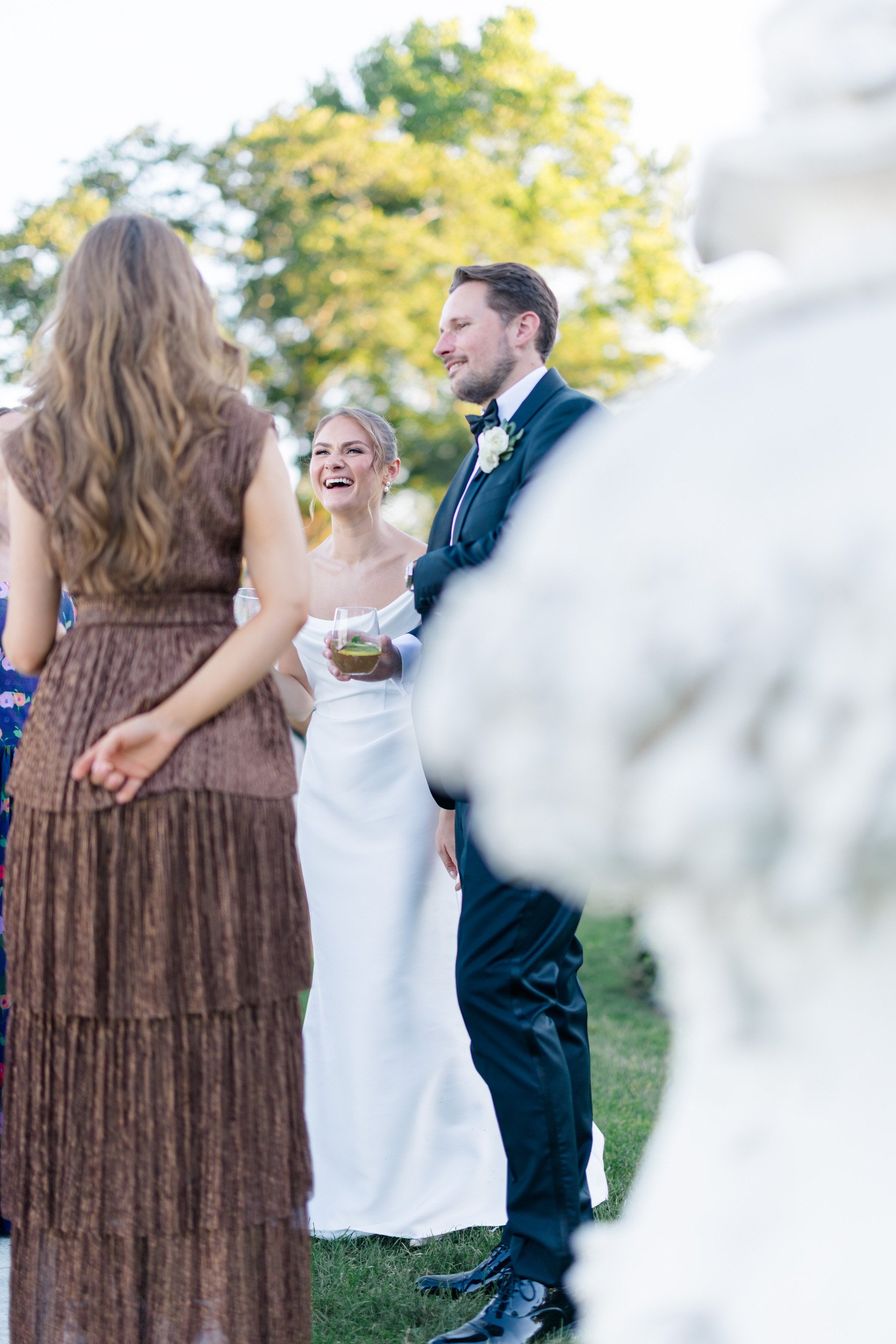 Guests mingling during cocktail hour at Rosecliff Mansion