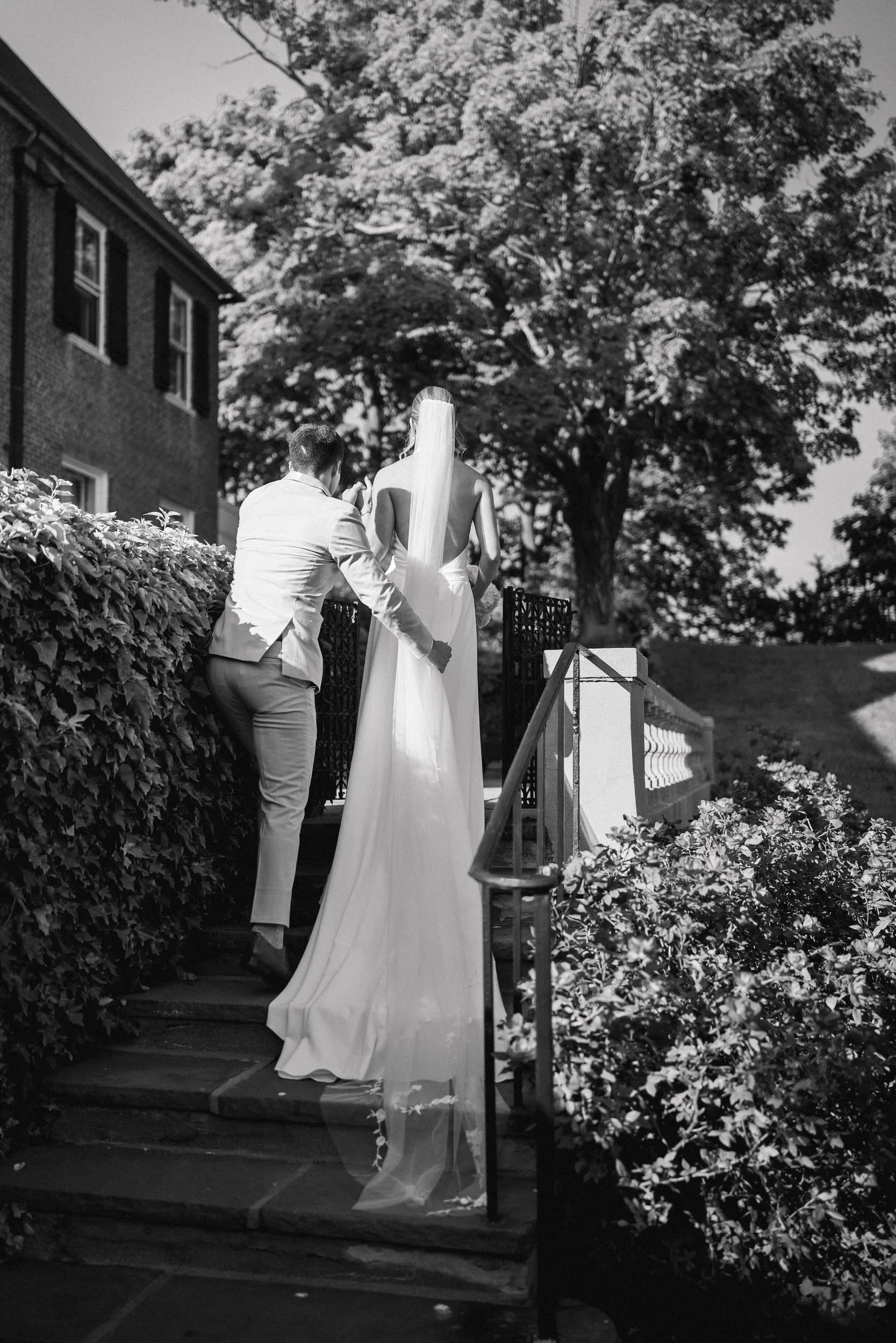 Couple sharing their first kiss as newlyweds during a coastal wedding ceremony.