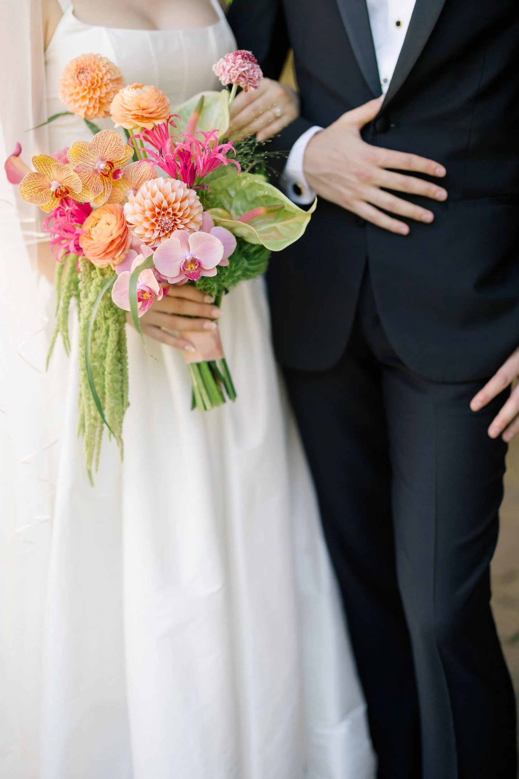 Romantic couple posing in garden setting at Topsfield MA wedding venue with vibrant florals