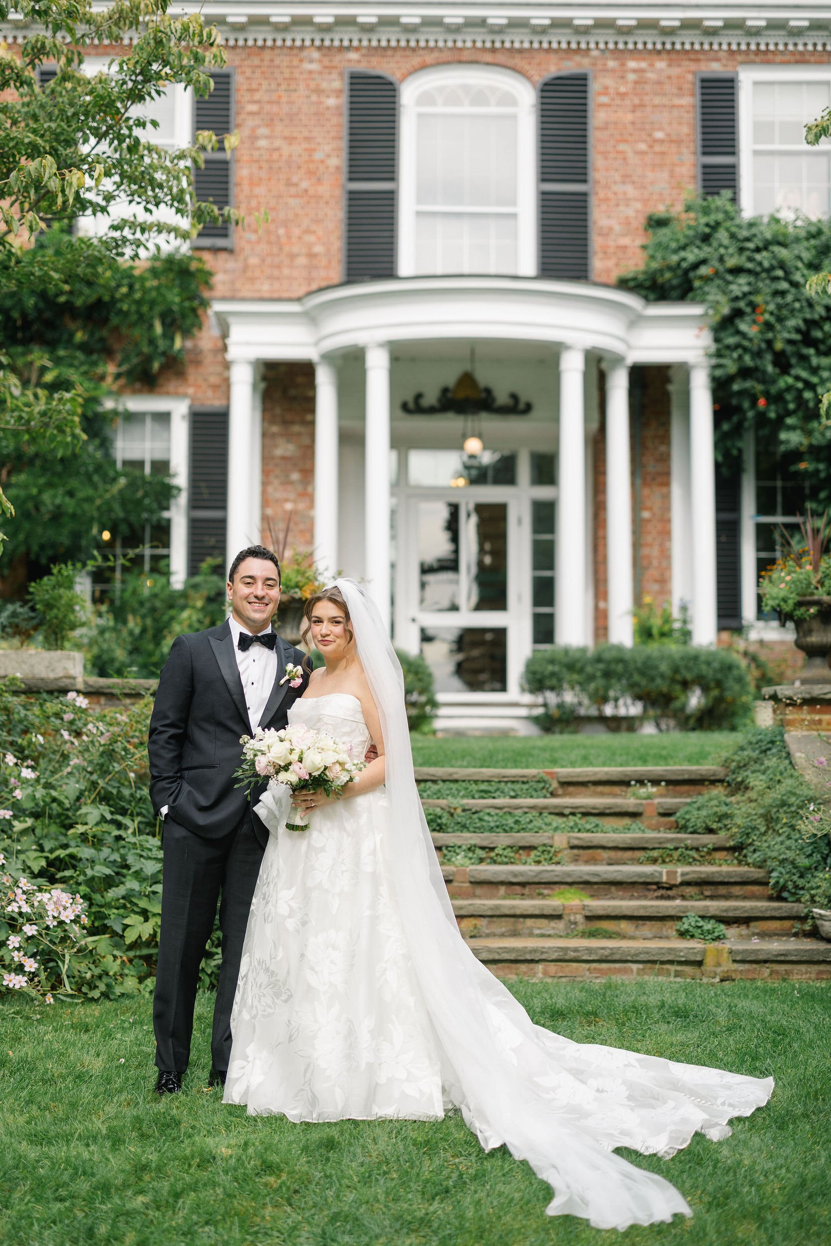 Newlyweds posing on the grounds of Long Hill in Beverly, Massachusetts.