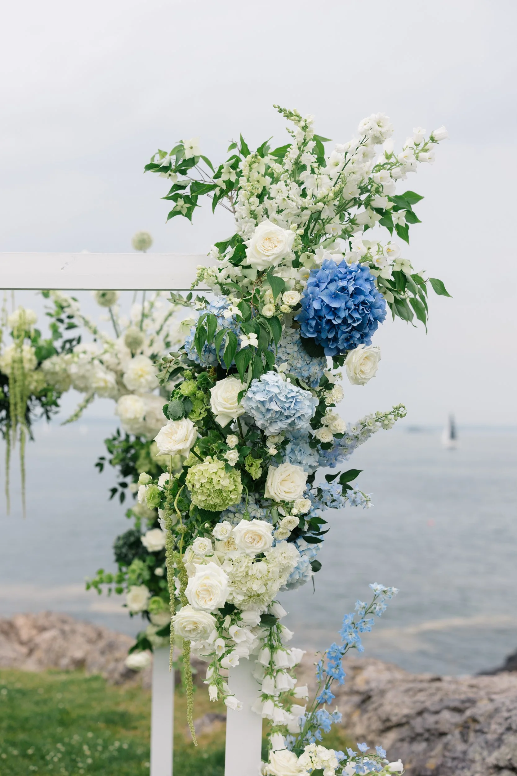 Coastal wedding ceremony details at Chandler Hovey Park with florals inspired by New England’s sail-filled harbor views.