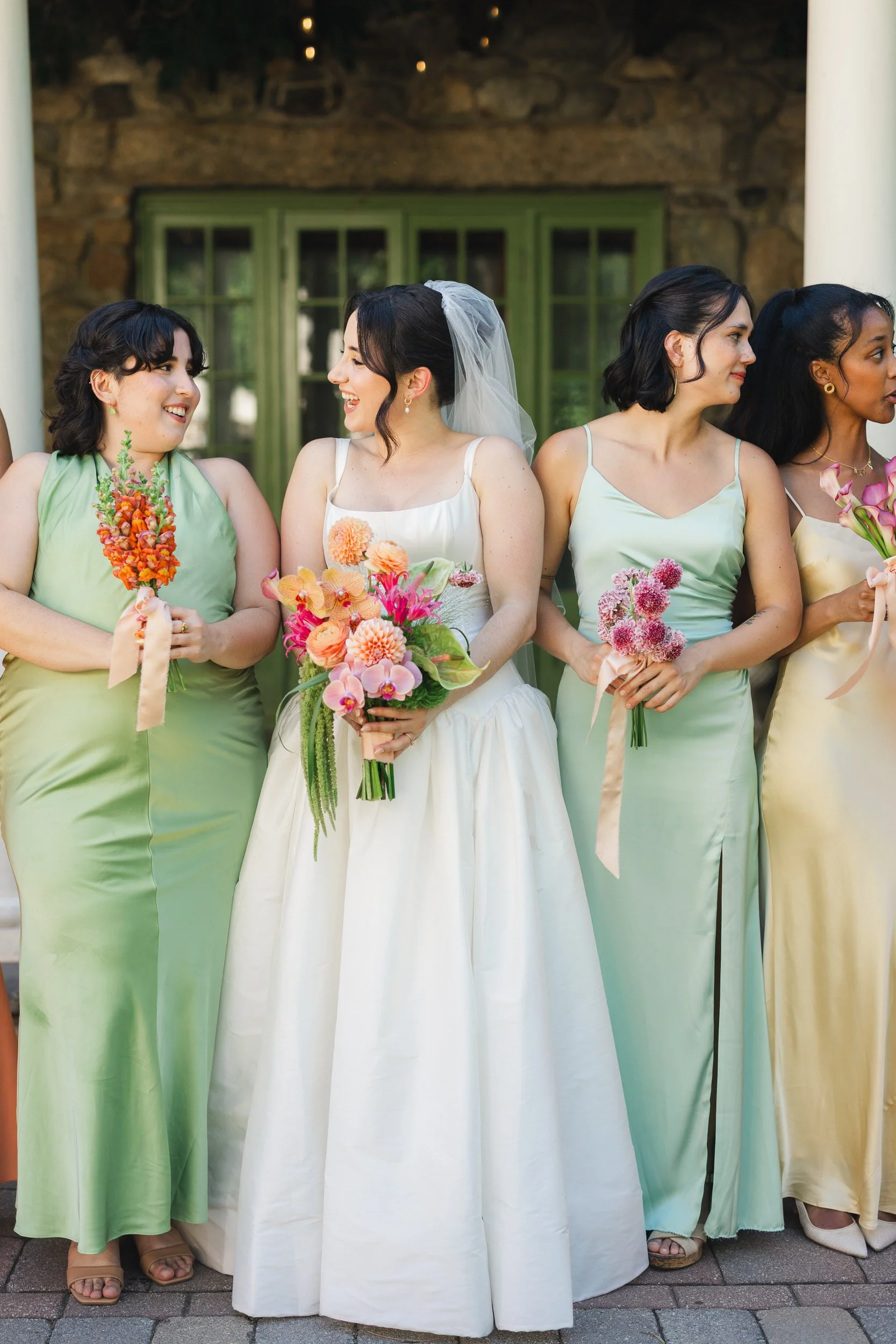 Bridal party detail showing each bridesmaid holding a different flower from bride’s bouquet at estate wedding