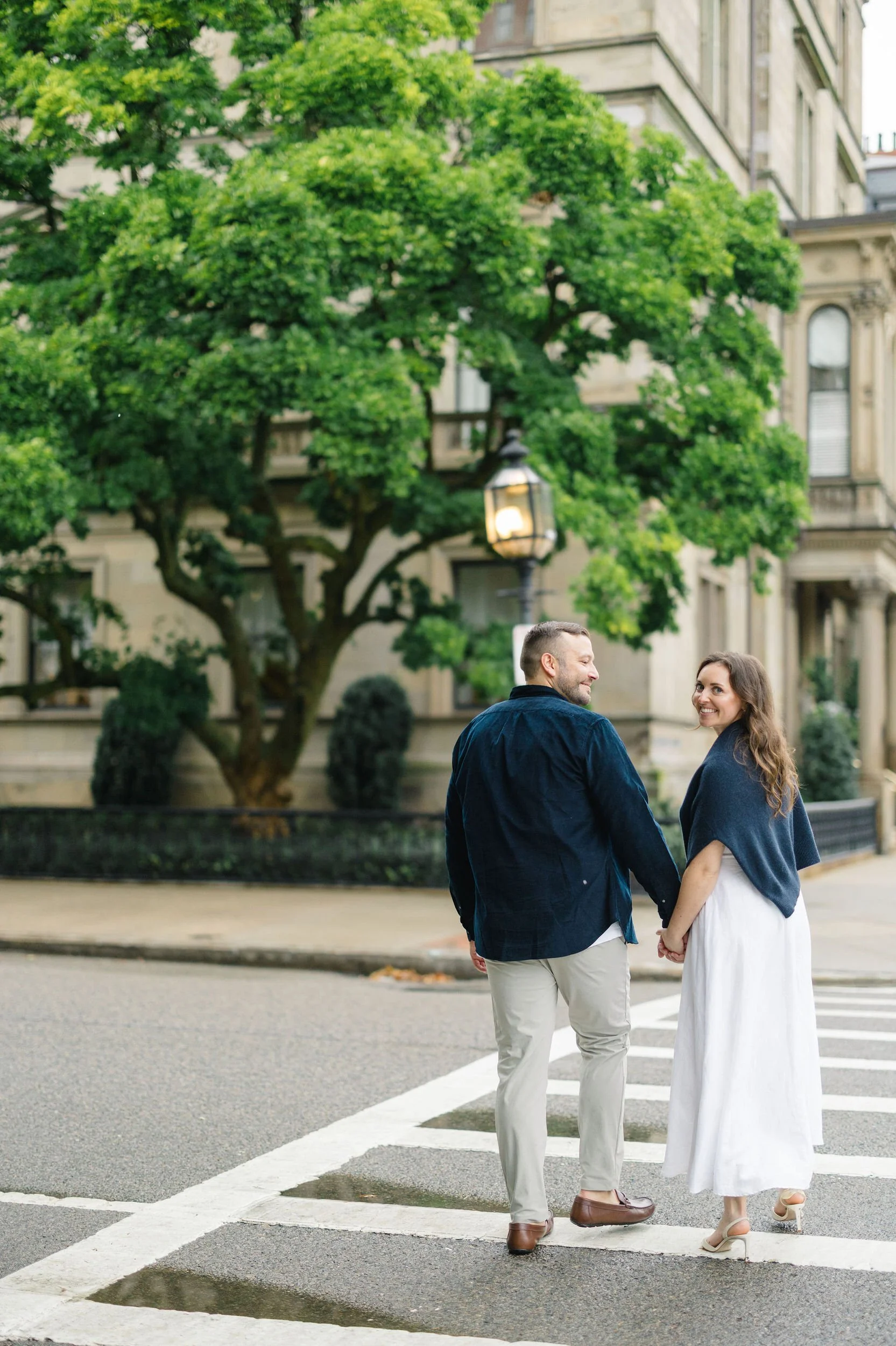Boston Public Garden couple portraits featuring lush greenery and winding paths