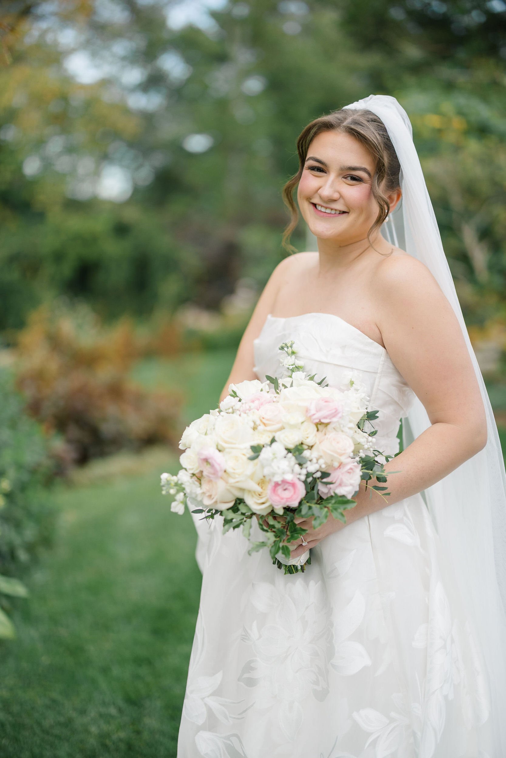 Bride posing among the greenery during her Long Hill wedding.