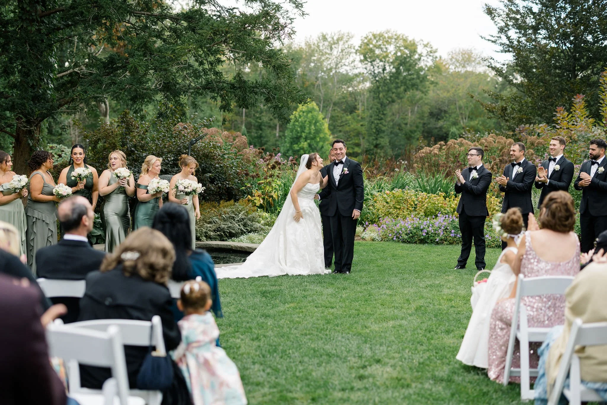 Couple exchanging vows during their Long Hill garden wedding ceremony.