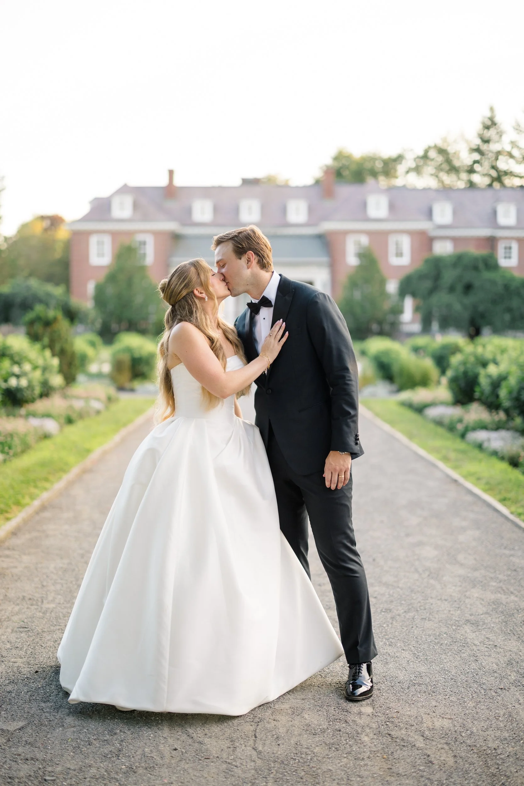 Bride and groom walking through the gardens at golden hour