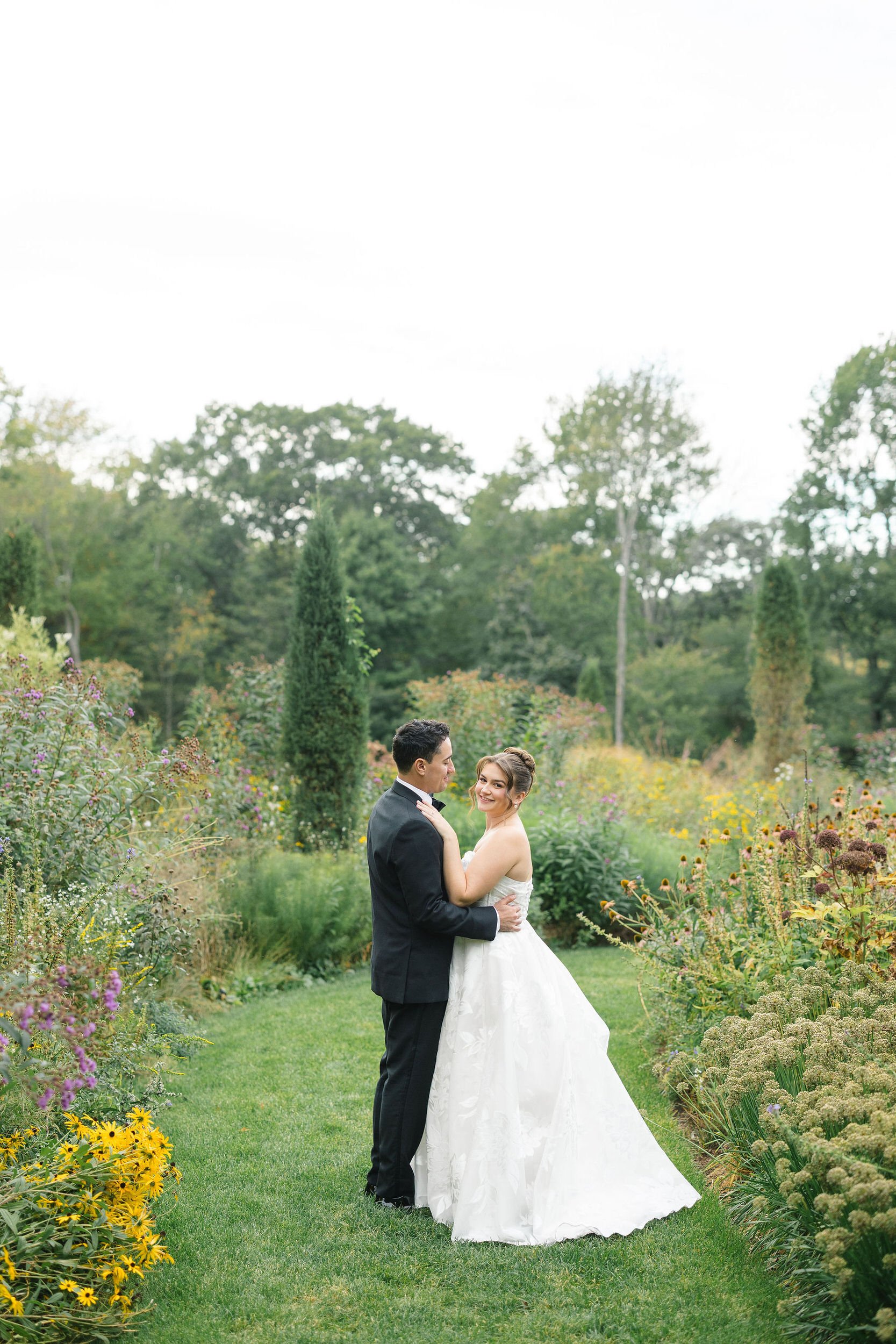 Wedding couple photographed in the gardens at Long Hill during golden hour.