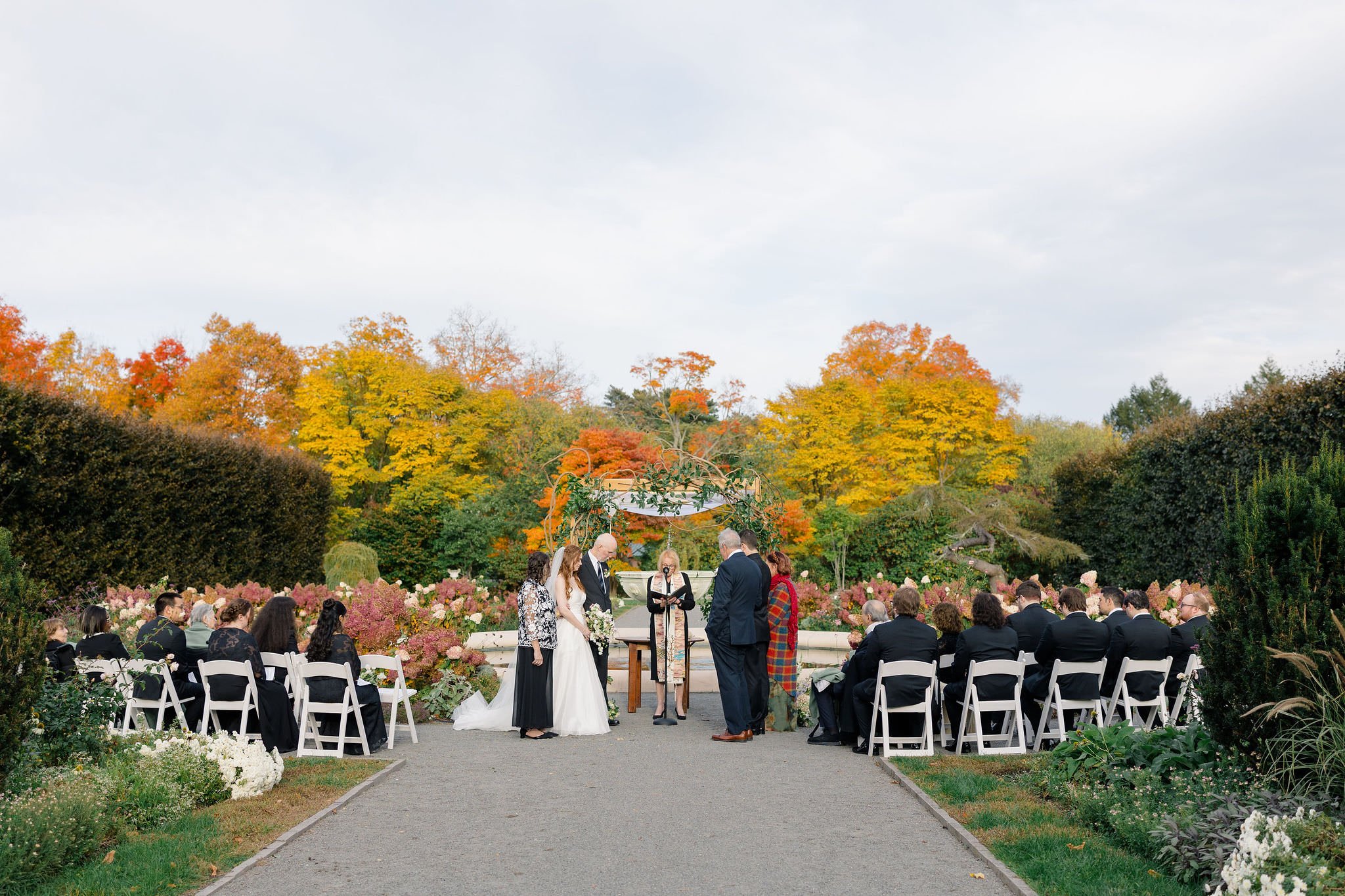 Wedding ceremony at Elm Bank in Wellesley, Massachusetts, surrounded by garden scenery.