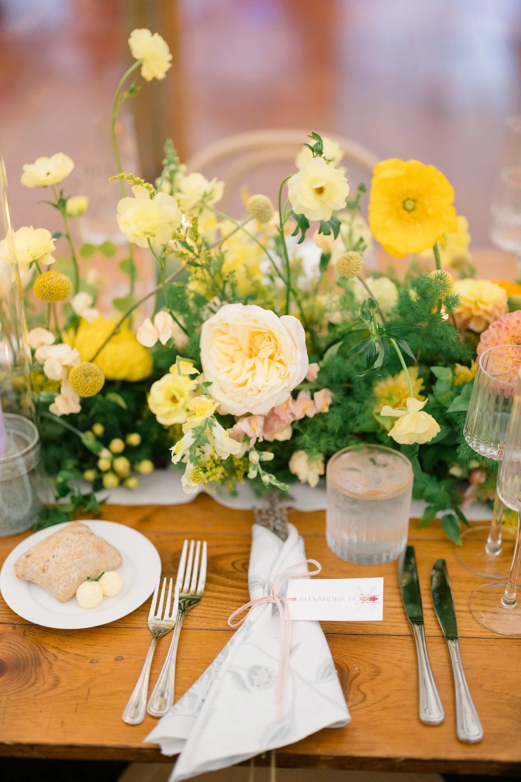 Colorful reception design featuring full-scale trees and abundant seasonal florals.