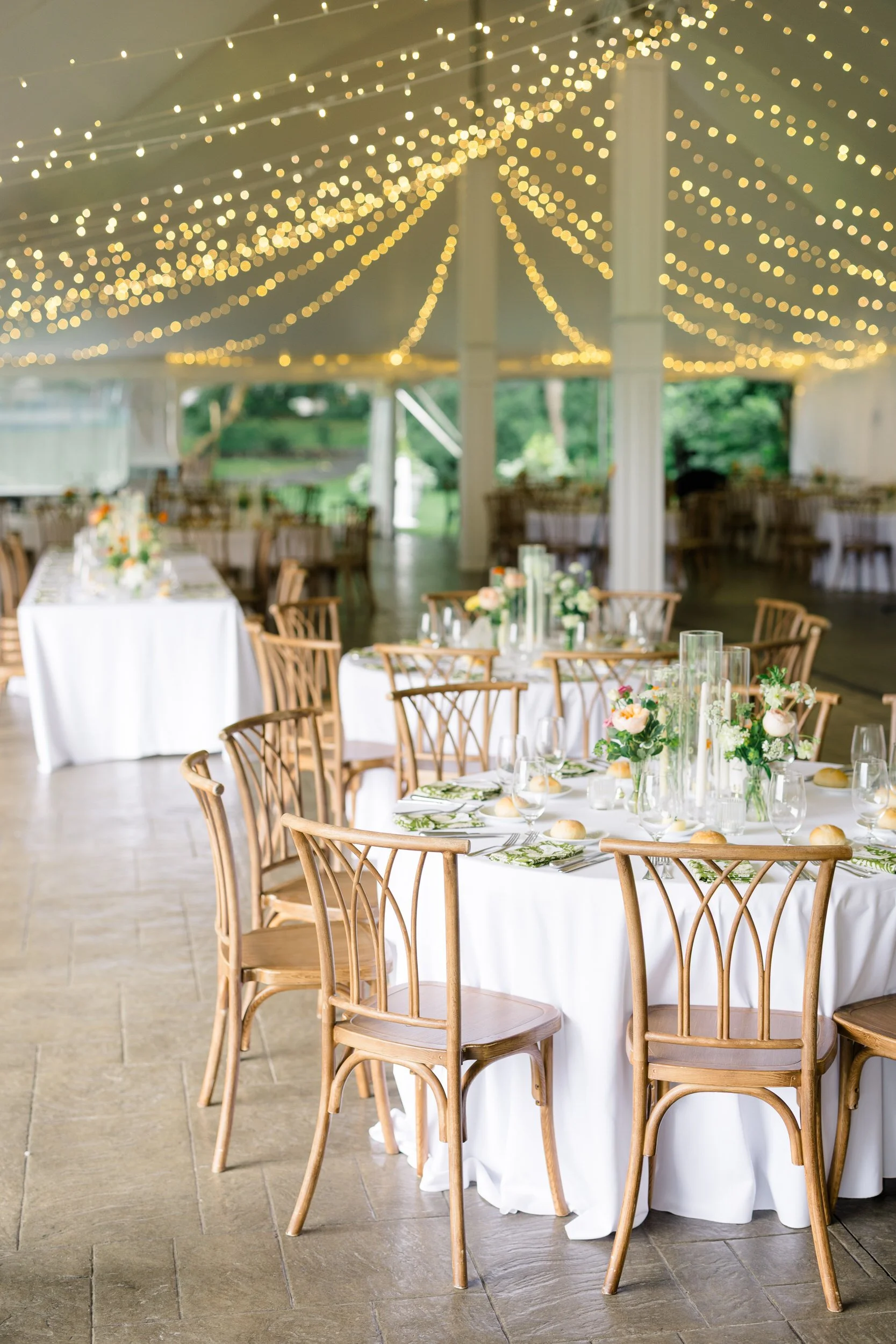 Reception tables decorated with colorful wildflower-inspired florals at Blithewold Mansion.
