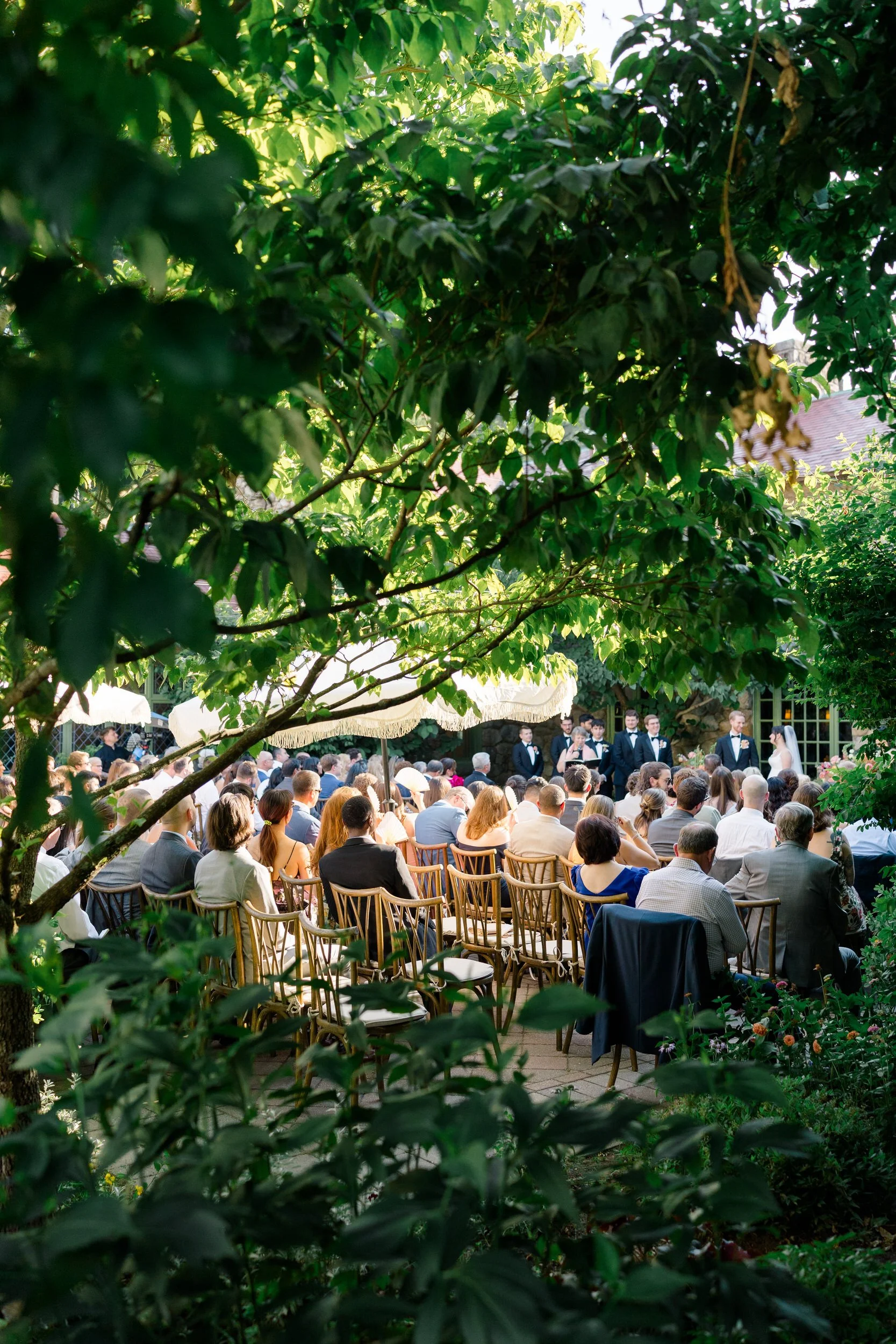 Colorful garden wedding ceremony surrounded by lush florals and greenery in Topsfield MA