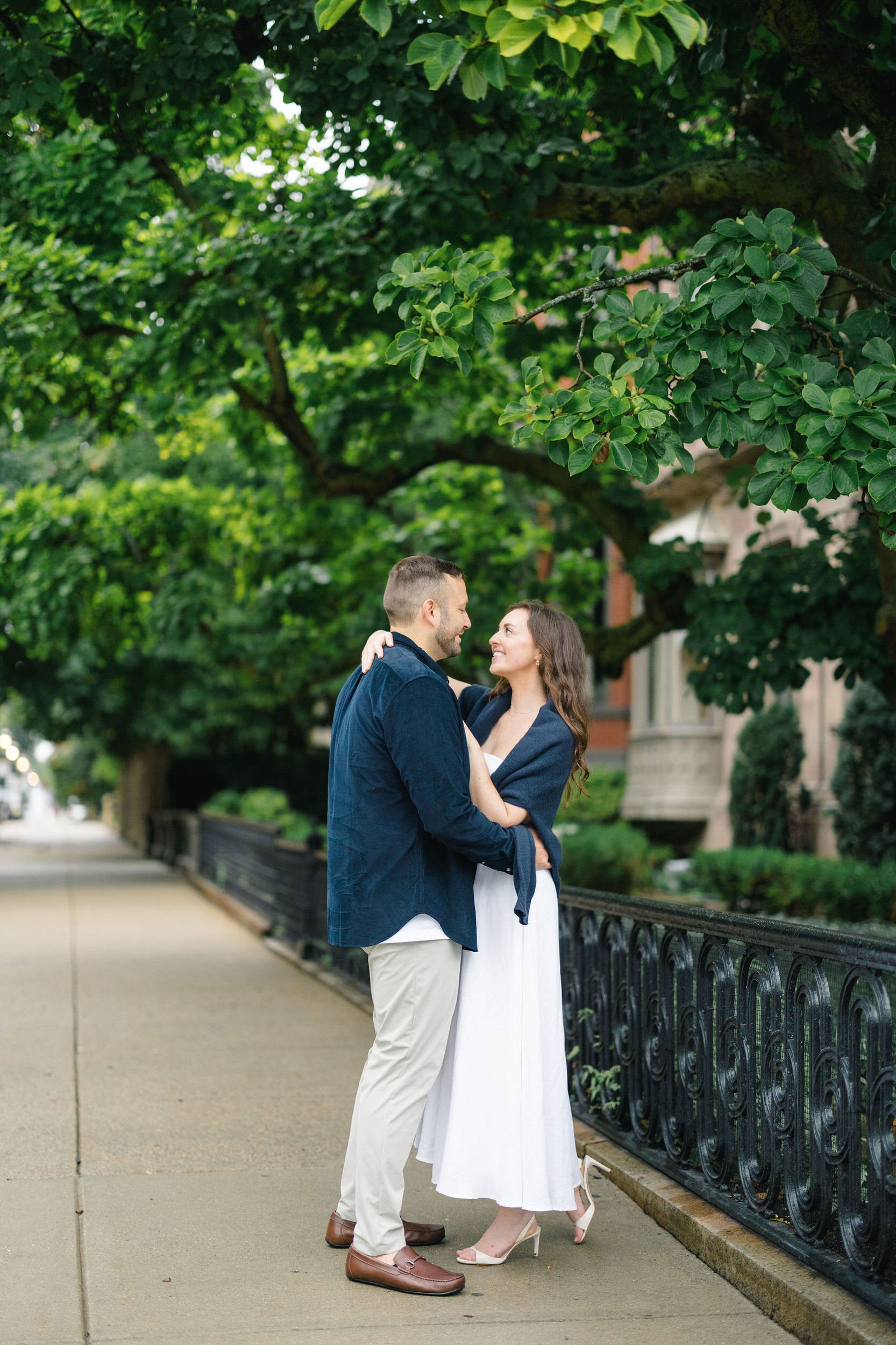 Couple embracing during an engagement photoshoot in the Boston Public Garden
