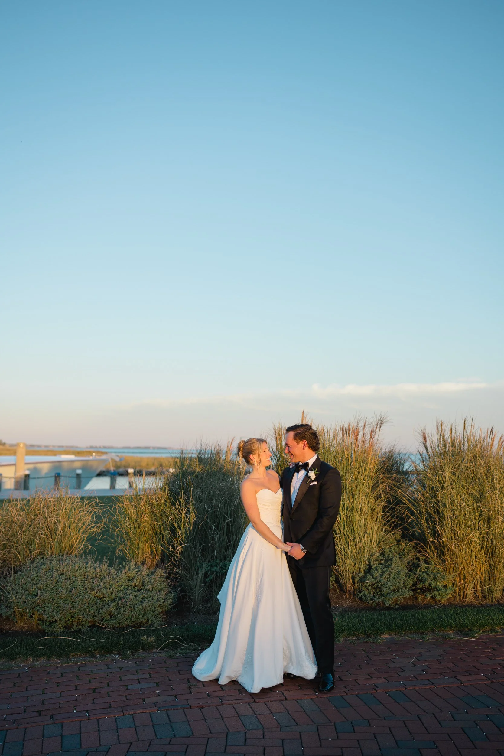 Sunset wedding portraits at Wychmere Beach Club on Cape Cod.