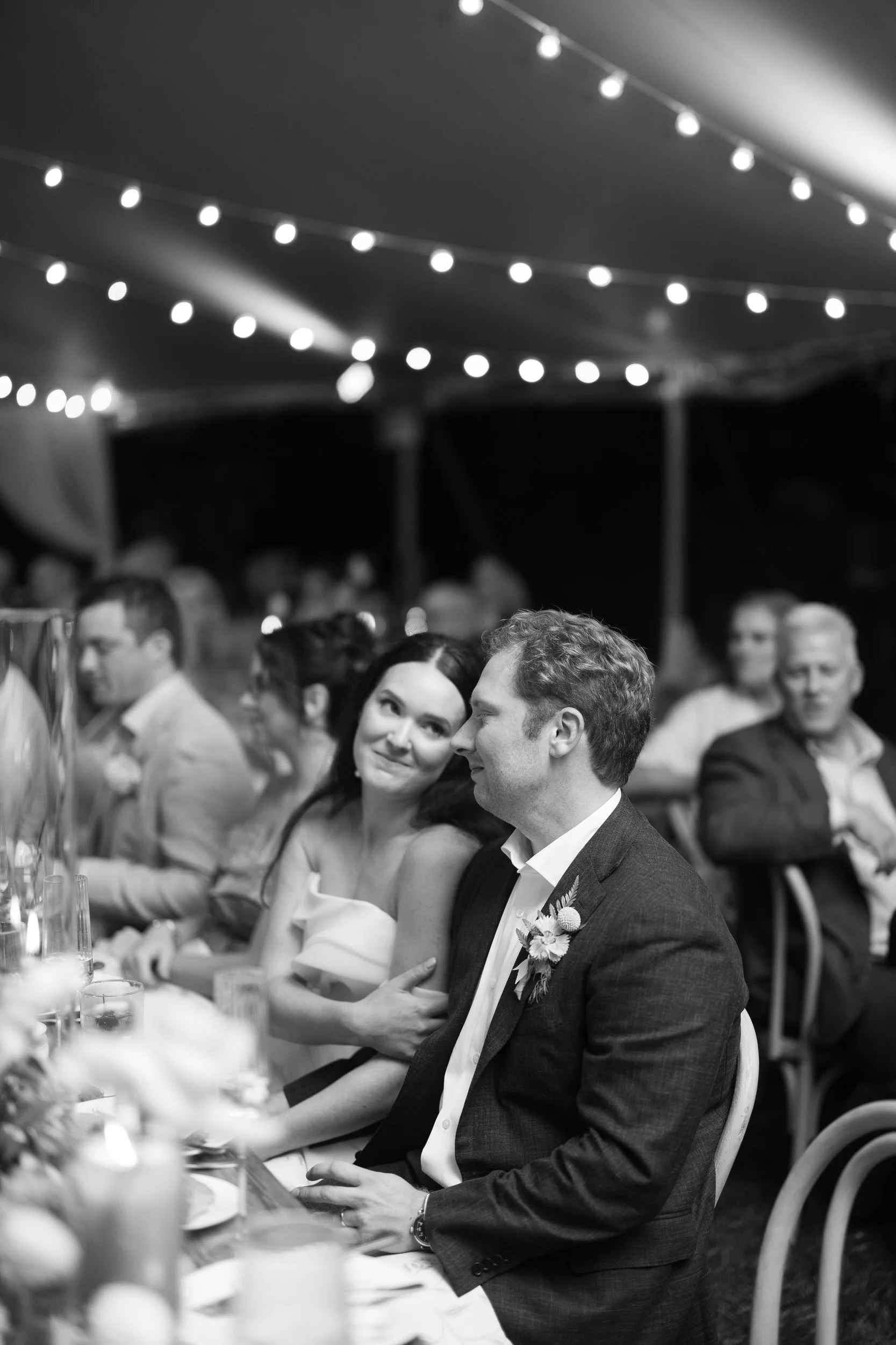 Colorful reception dinner surrounded by bright pink, orange, yellow, coral, and red flowers.