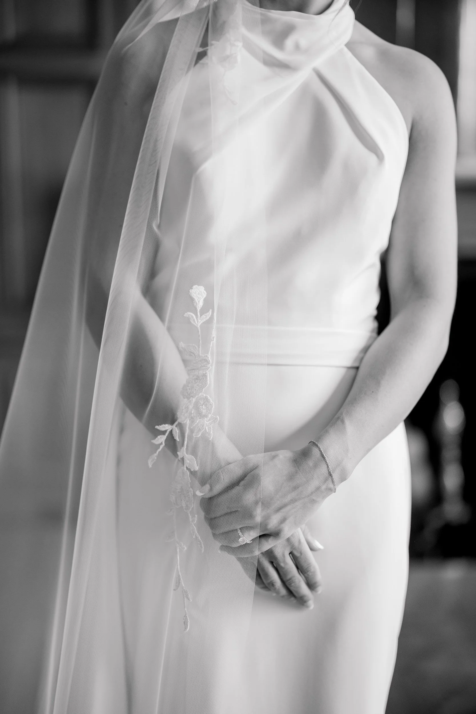 Bride having finishing touches applied before a coastal garden party wedding.