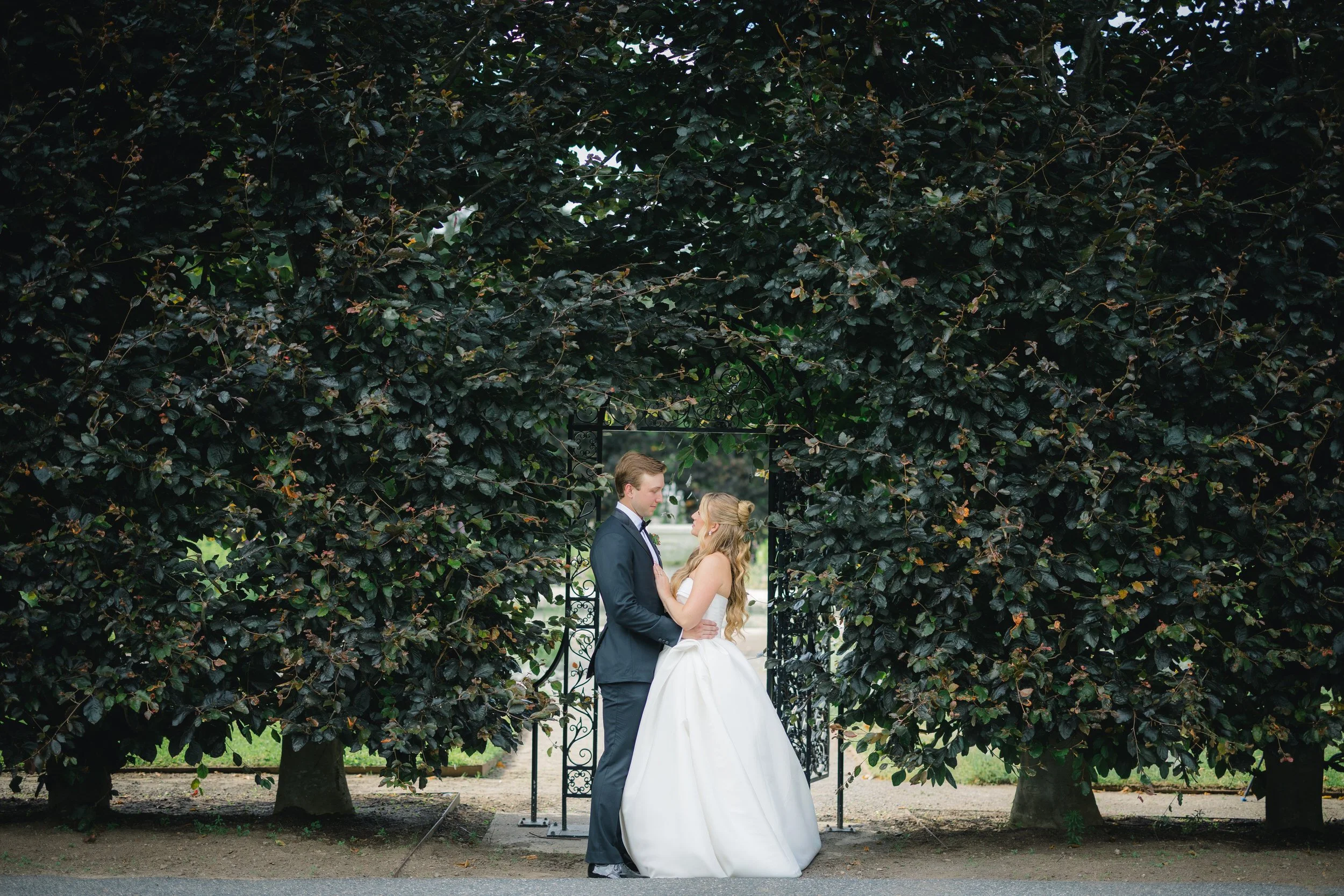 Newlywed couple walking through the gardens during their Elm Bank wedding